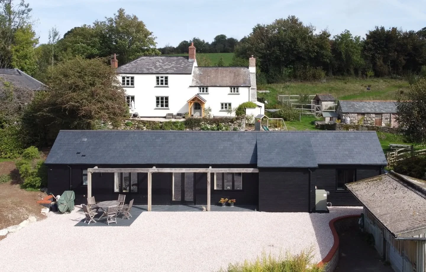 Barn conversion build complete.

From a former piggery into a low energy two bedroom annexe. A modest front extension creates an entrance porch linked with an oak framed pergola that will one day have roses growing over it to provide sun shading.

An