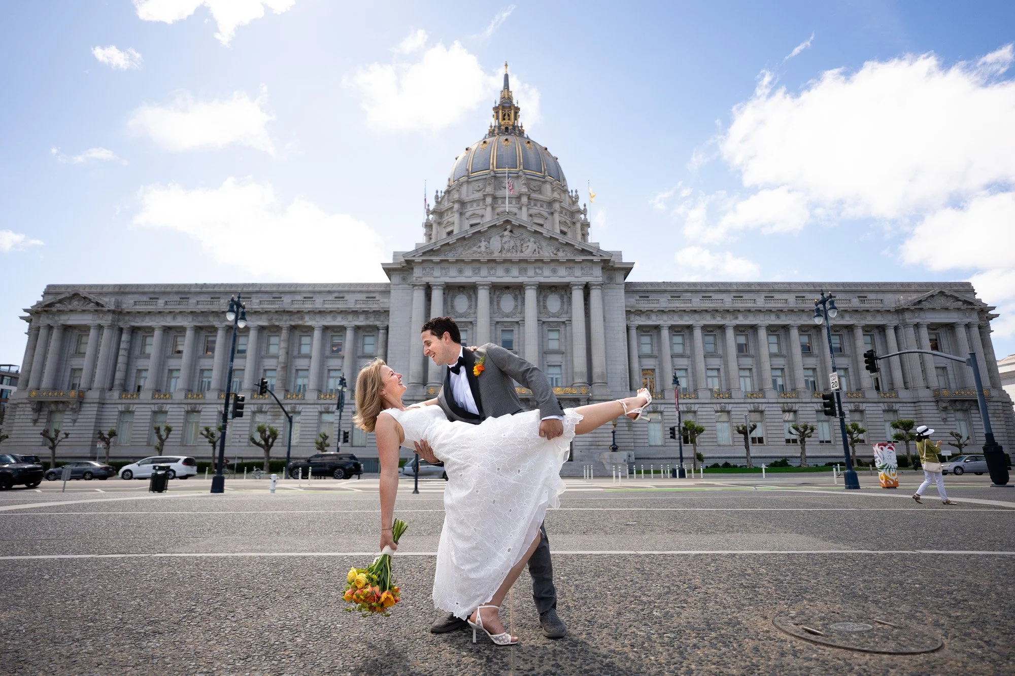 Groom dipping bride at San Francisco City Hall wedding