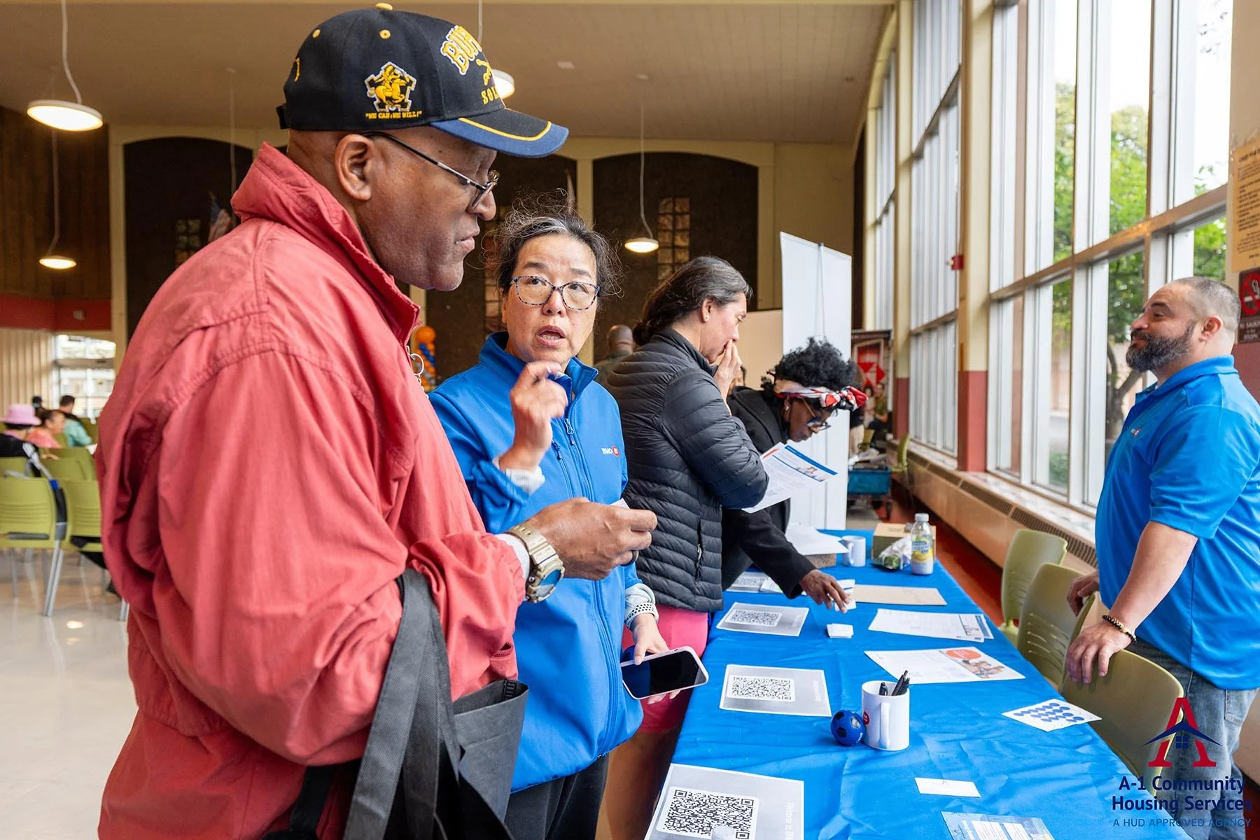 people picking up information from a BMO booth at the annual housing fair