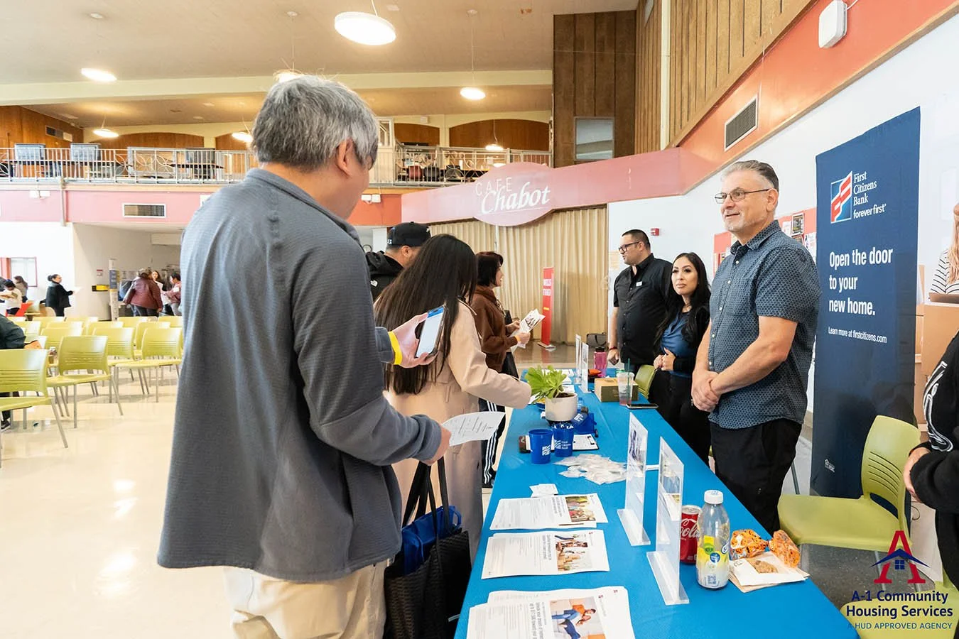 first-citizens-bank-employees-giving-out-information-at-booth-to-housing-fair-participants.jpg
