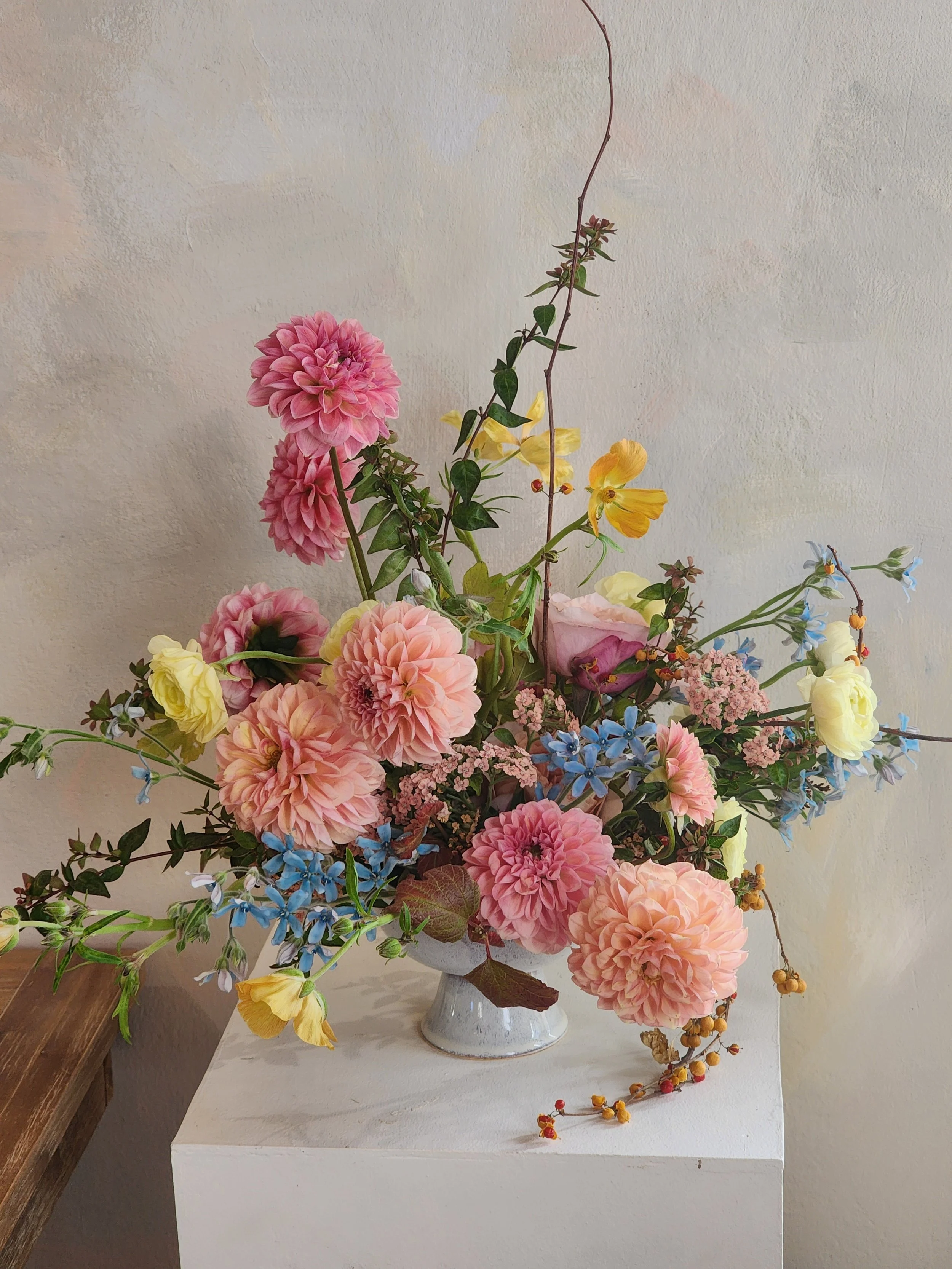 Statement wedding flowers featuring sculptural dahlias and willow branches, butter yellow ranunculus and baby blue tweedia. North Bay Wedding flowers. Napa Wedding flowers. Sonoma Wedding flowers. Sea Ranch Wedding flowers. 