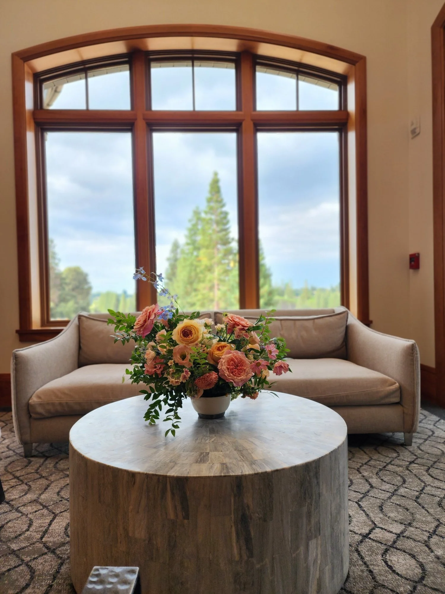Romantic floral arrangement of garden roses and colorful seasonal flowers at Sharon Heights Country Club in Menlo Park, California, styled for a wedding lounge area with views of the surrounding gardens.