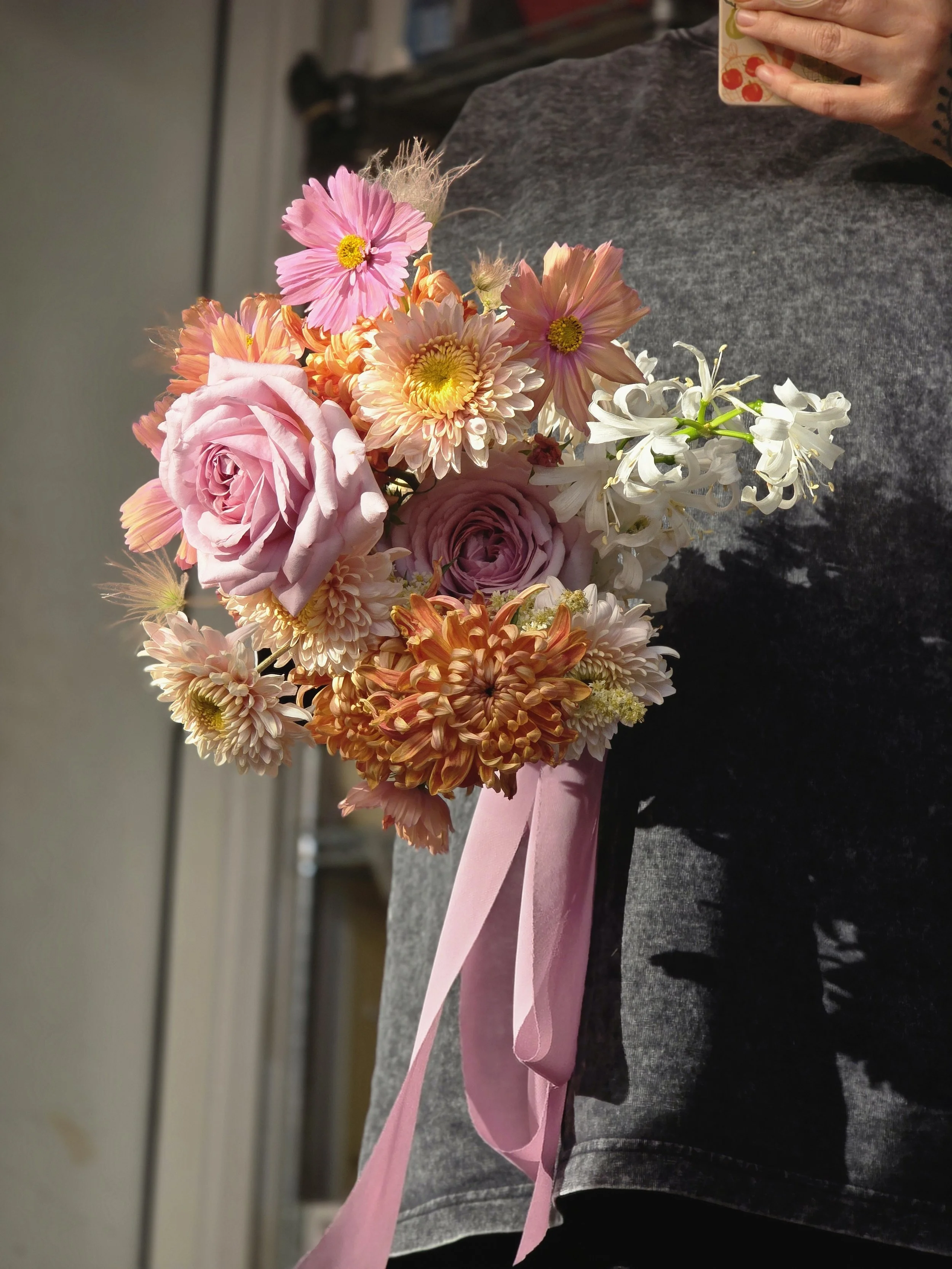 Lush pink, peach, and white bouquet with a trailing silk ribbon, bridal florals by Petal and Salt Floral