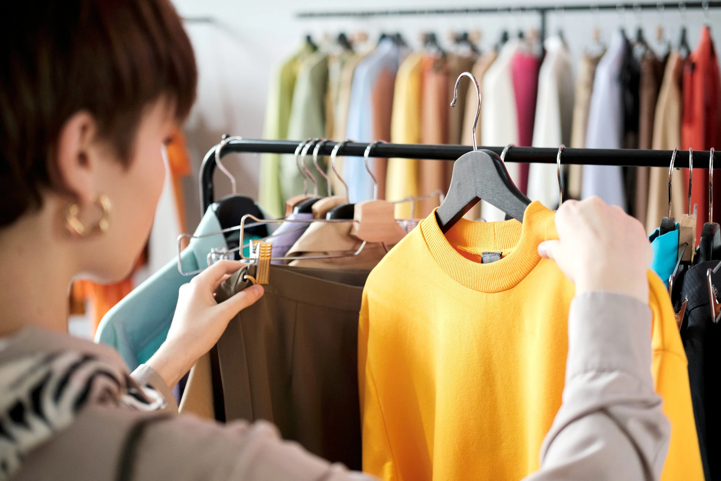 Person looking through clothing rack