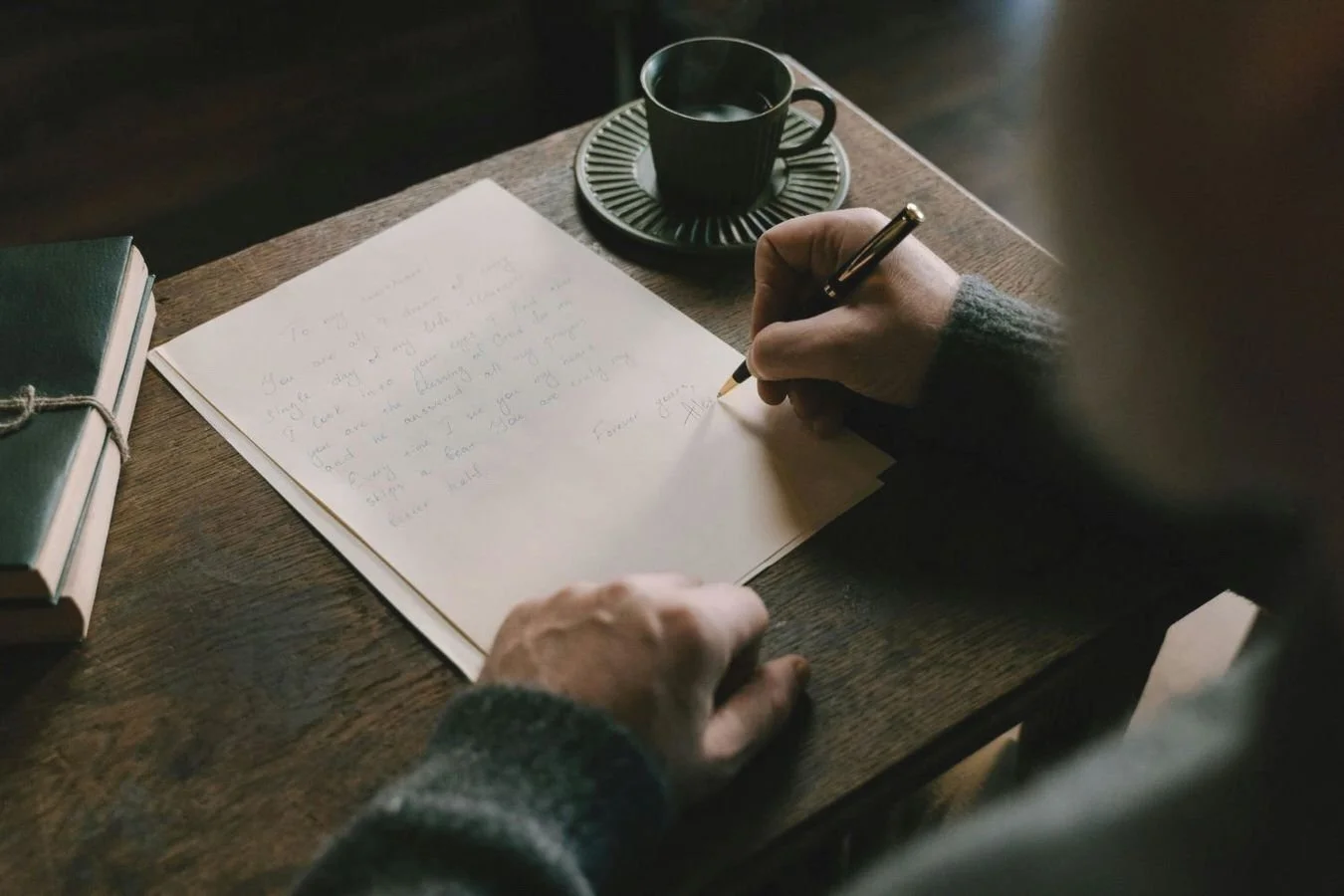 middle age man handwrites letter of appreciation to his lifelong sweetheart