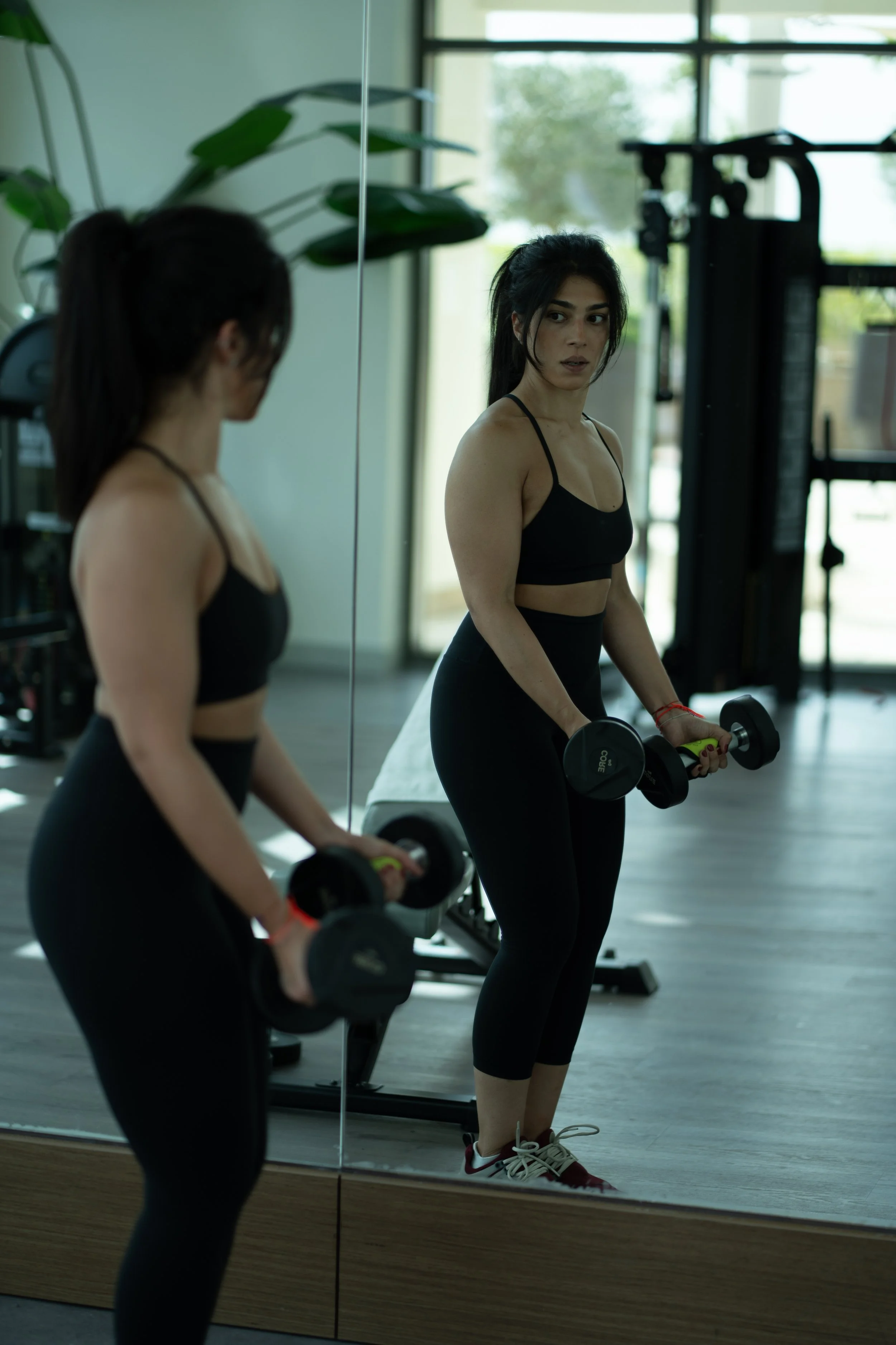 Madina Shukoor https://www.linkedin.com/in/madina-shukoor/ woman lifting
Woman exercising with dumbbells in a gym