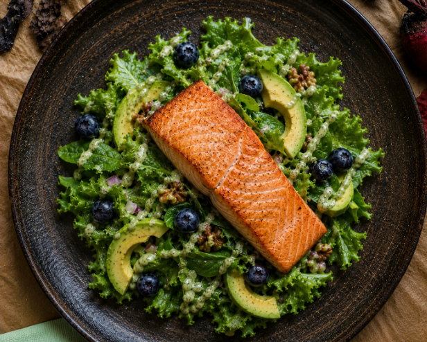 Baked wild salmon over kale salad with avocado and blueberries