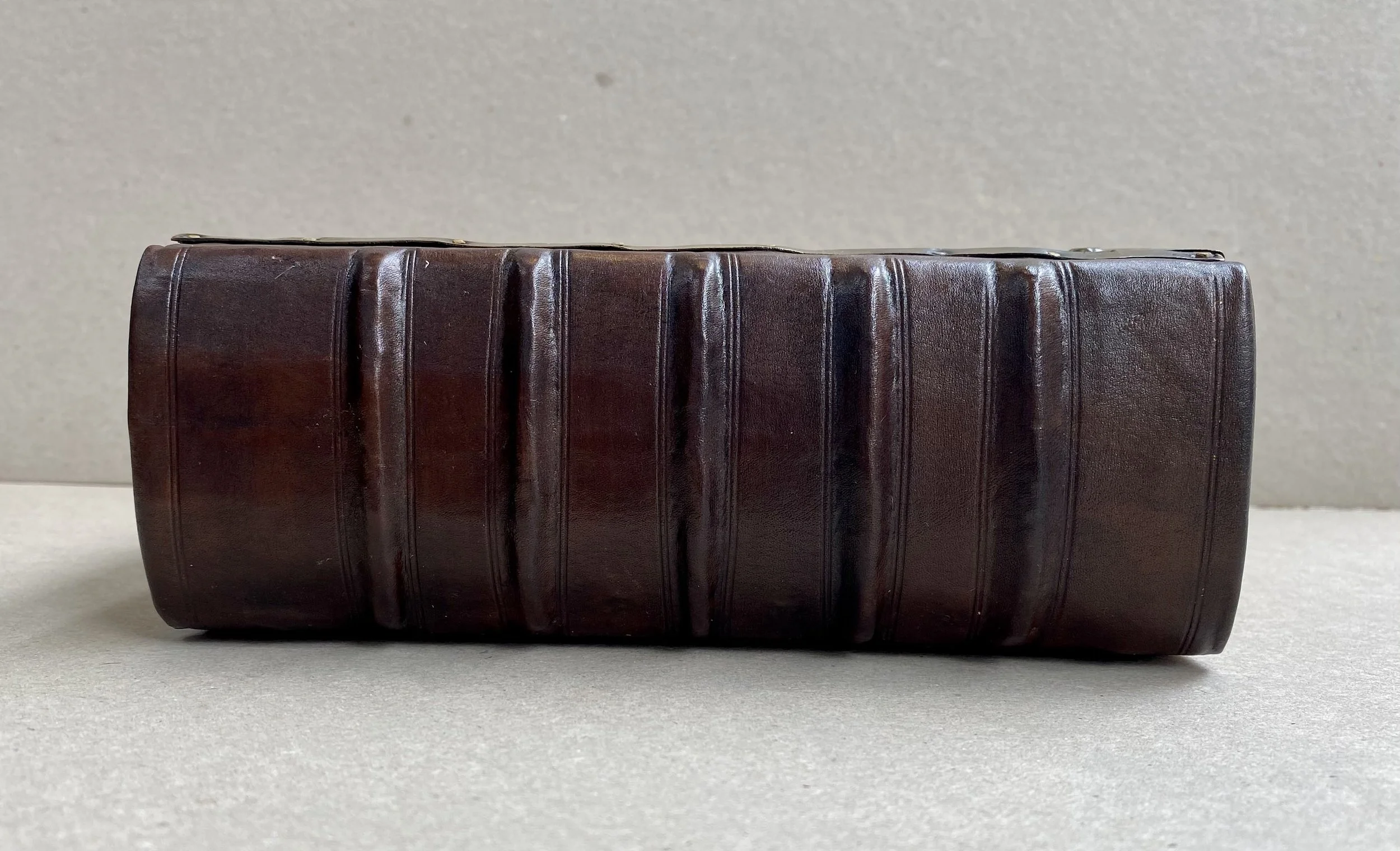 Repaired and rebacked brown leather spine of 18th century bible