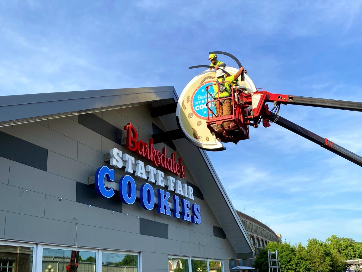 Crew member installs Iowa State Fair Barksdale Cookies Building Sign