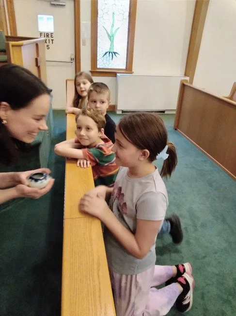 Pastor Emily give ashes to a child on Ash Wednesday