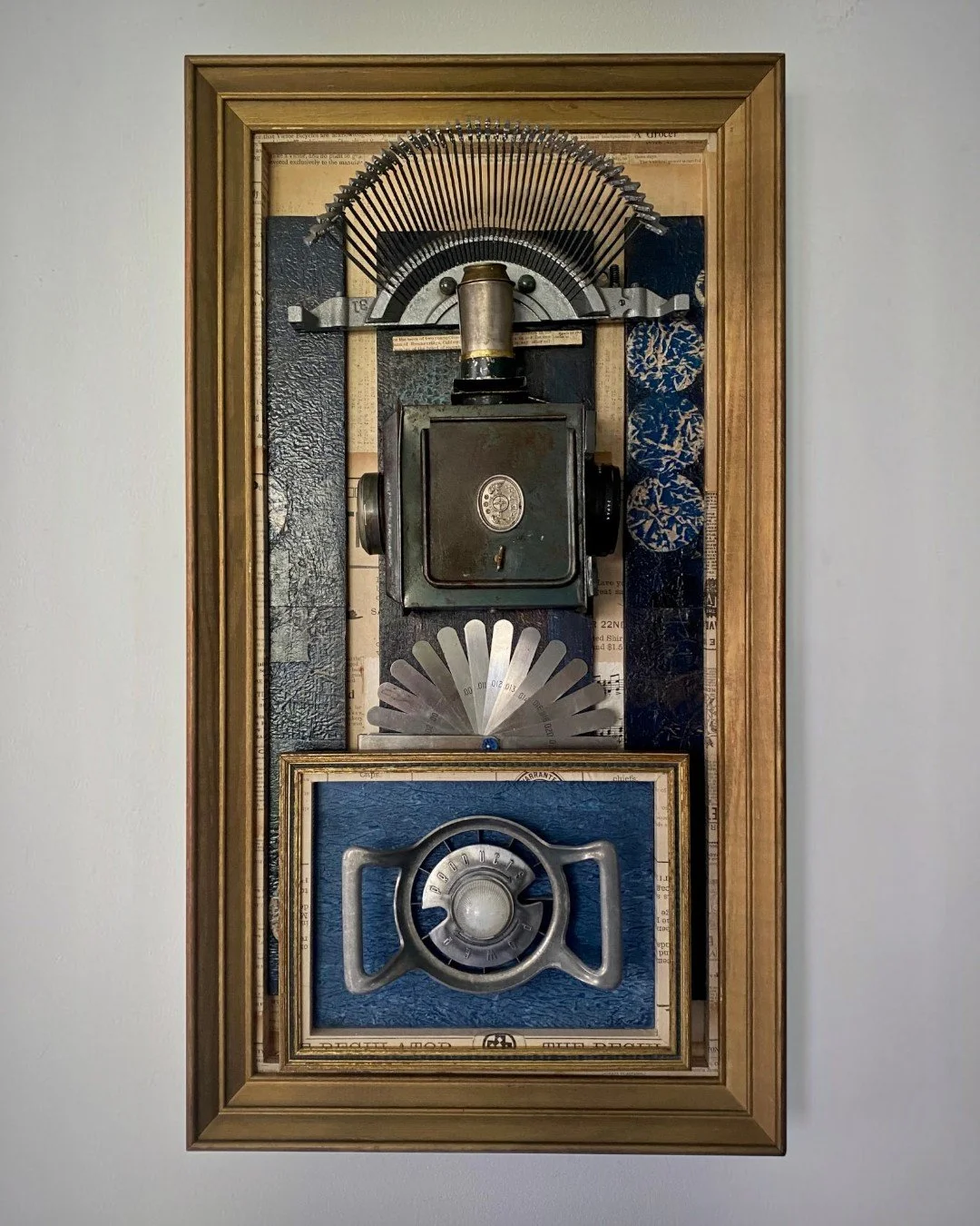 Assemblage artwork featuring vintage optical instruments and precision measuring tools arranged within a layered composition.