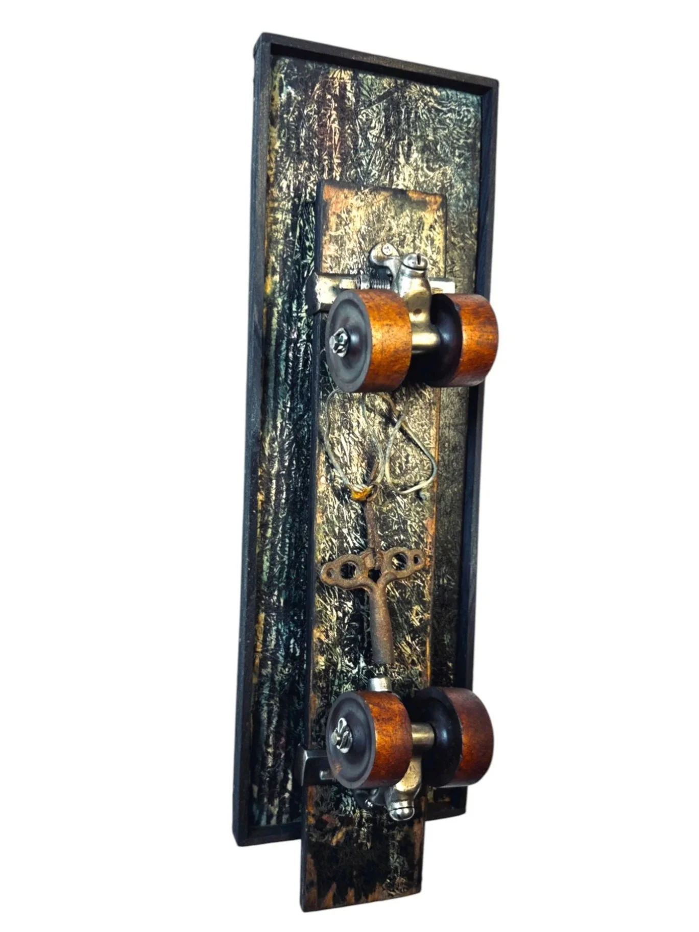 Angled side view revealing dimensional framing and partial view of skate wheels and key with looped wire
