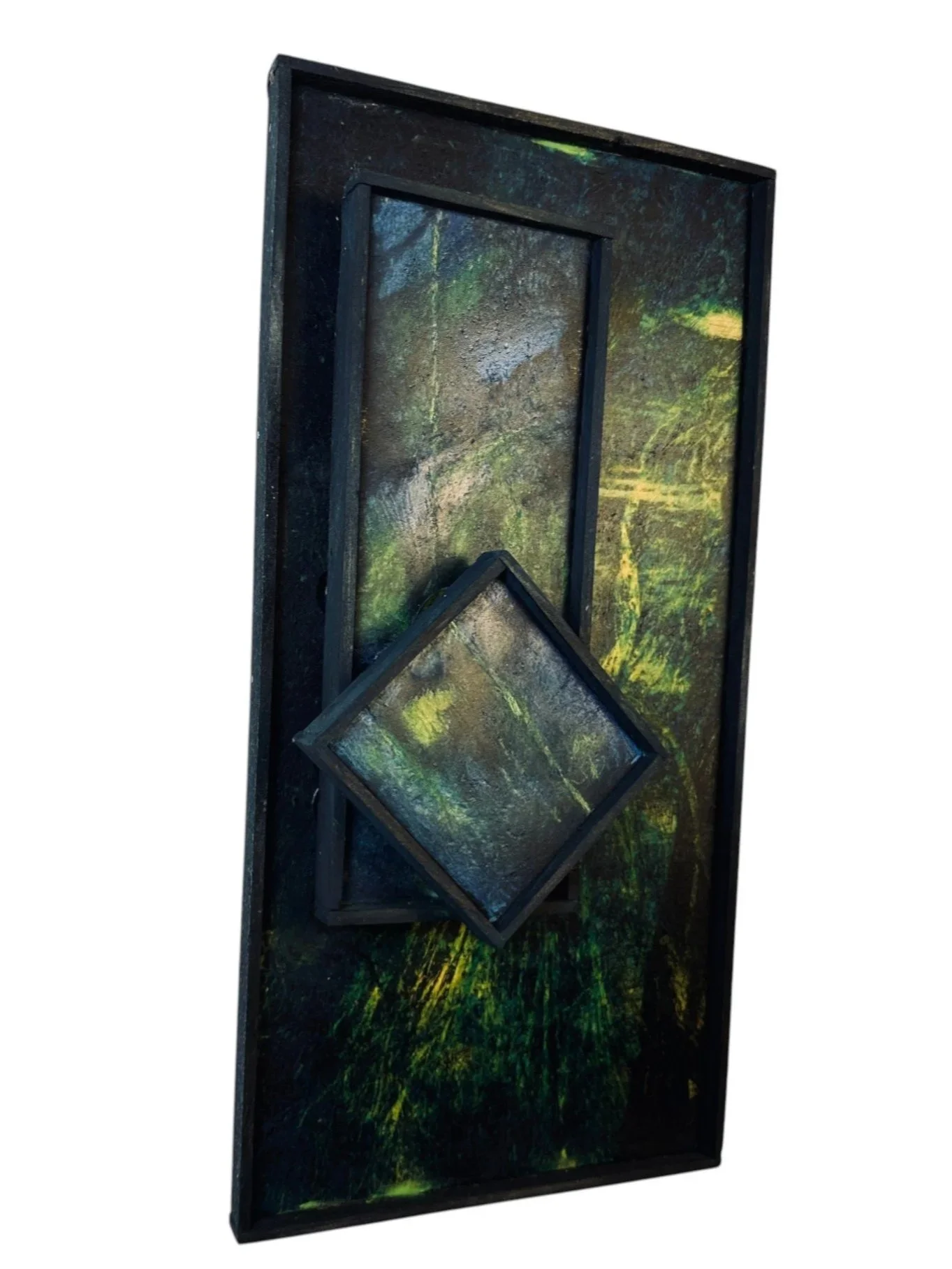 Angled side view showing depth of the nested square and rectangular panels against a dark green and yellow background.