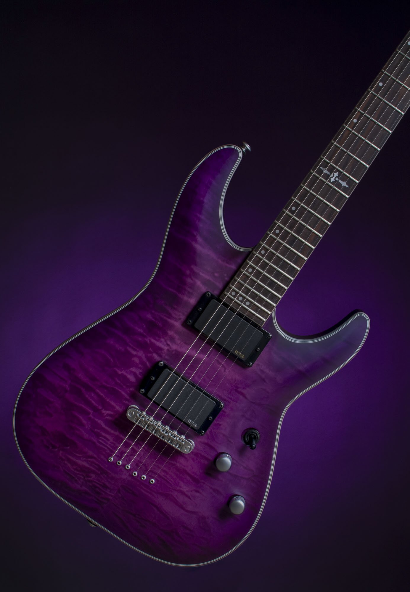 A purple electric guitar with a quilted maple top, black pickups, and a black background.