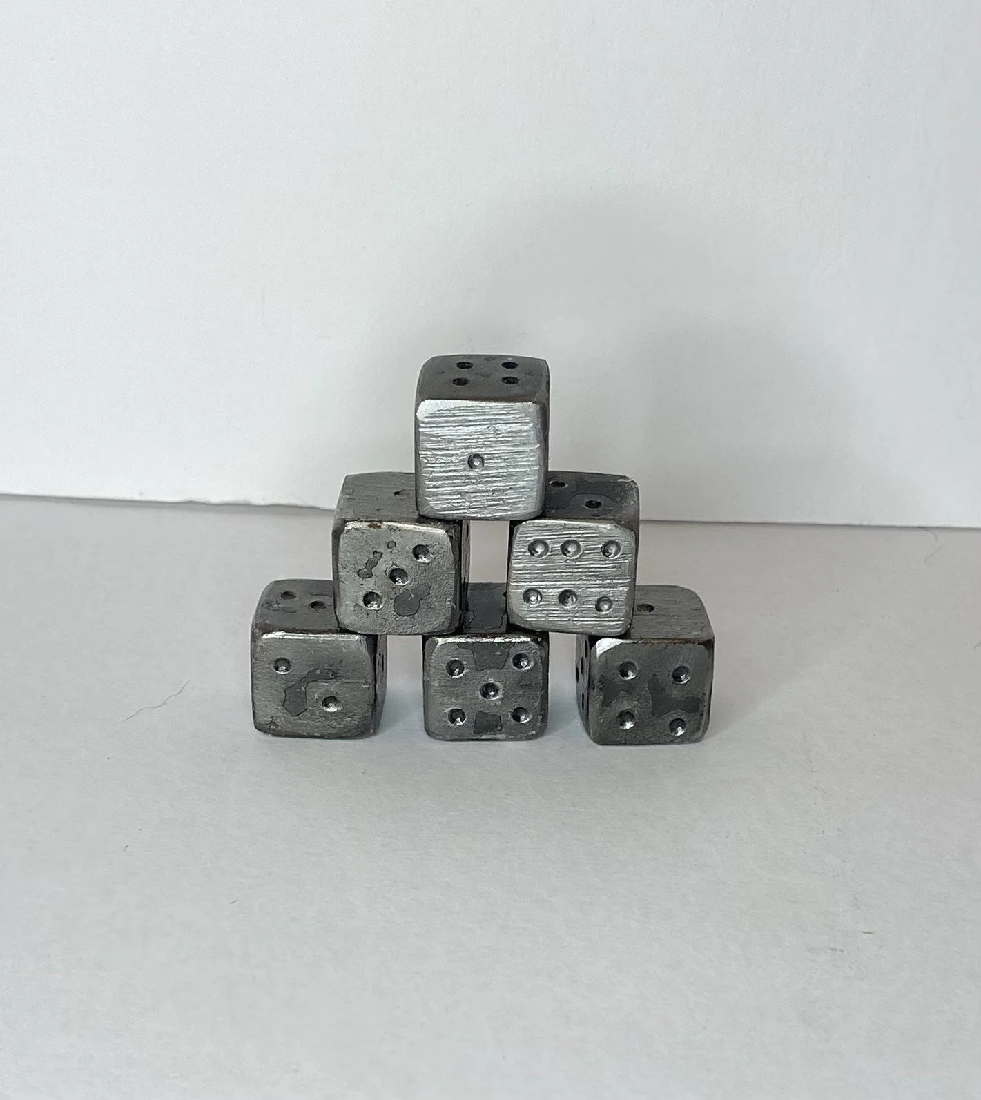 Hand forged steel dice.