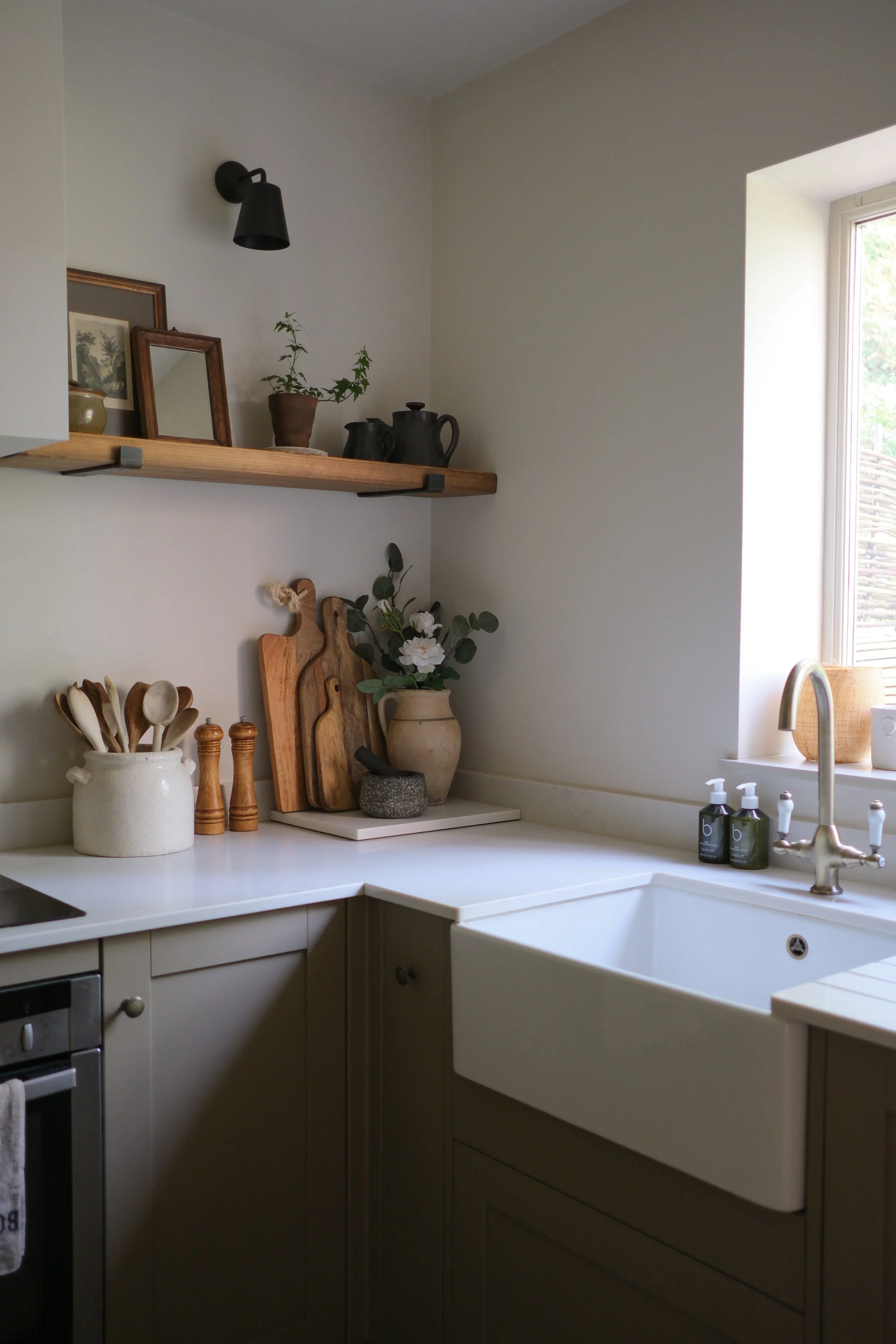 Bespoke Cotswolds kitchen interior design with farmhouse sink, oak shelving and country style details
