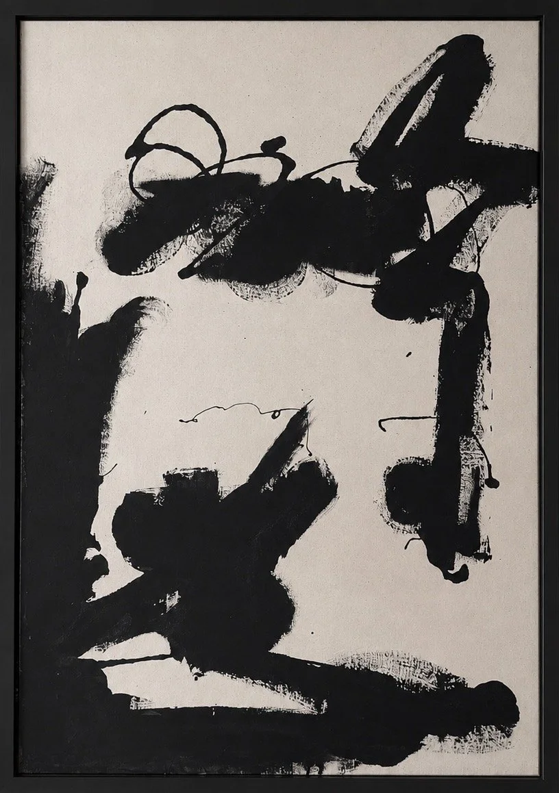 Abstract black ink brushstrokes on a white background in a framed artwork.