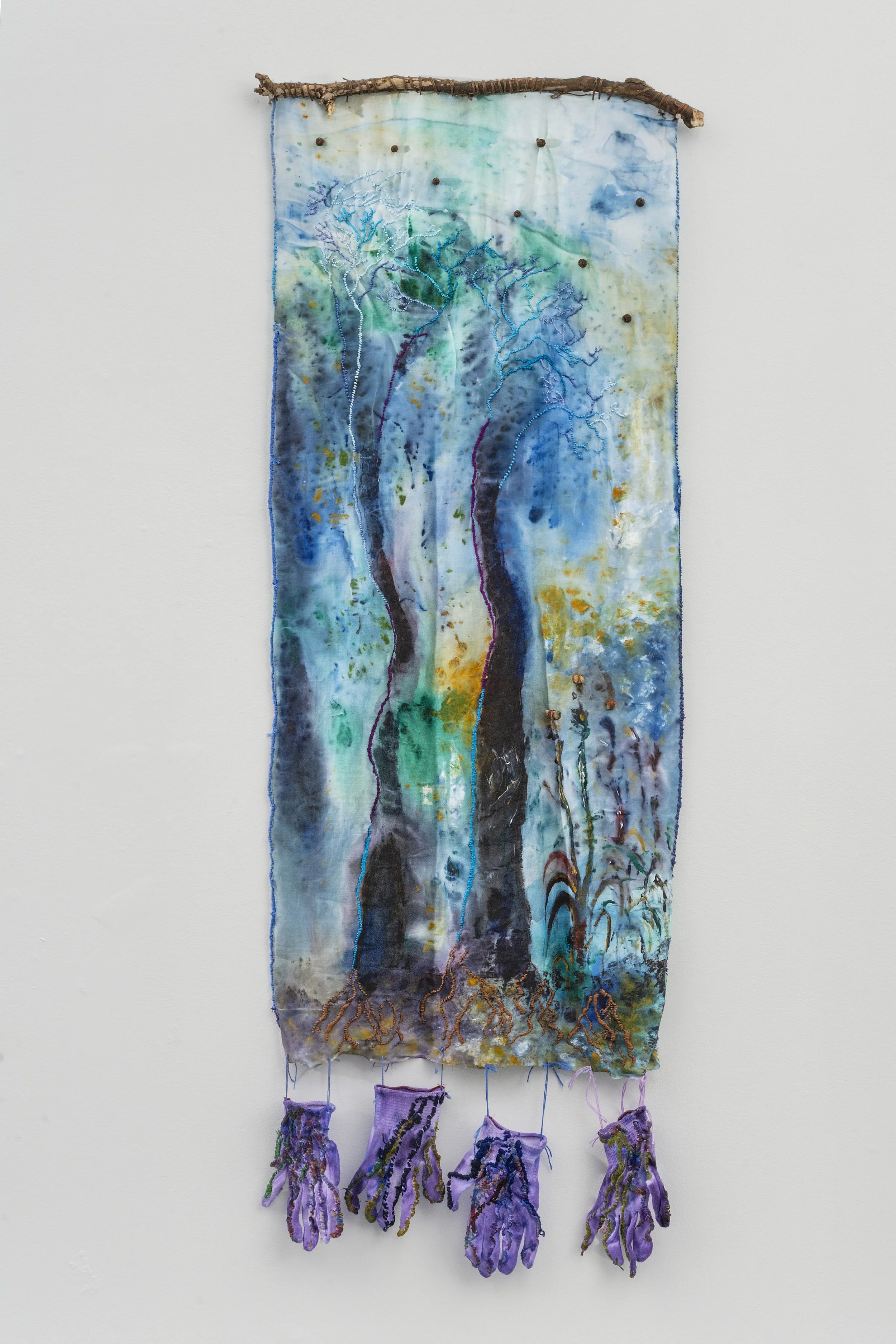 Melinda Kiefer Santiago,
Hand Roots, 2025, acrylic, embroidery, soils, stones, branch, wooden beads, repurposed gloves, 42 x 24 x 2 inches.