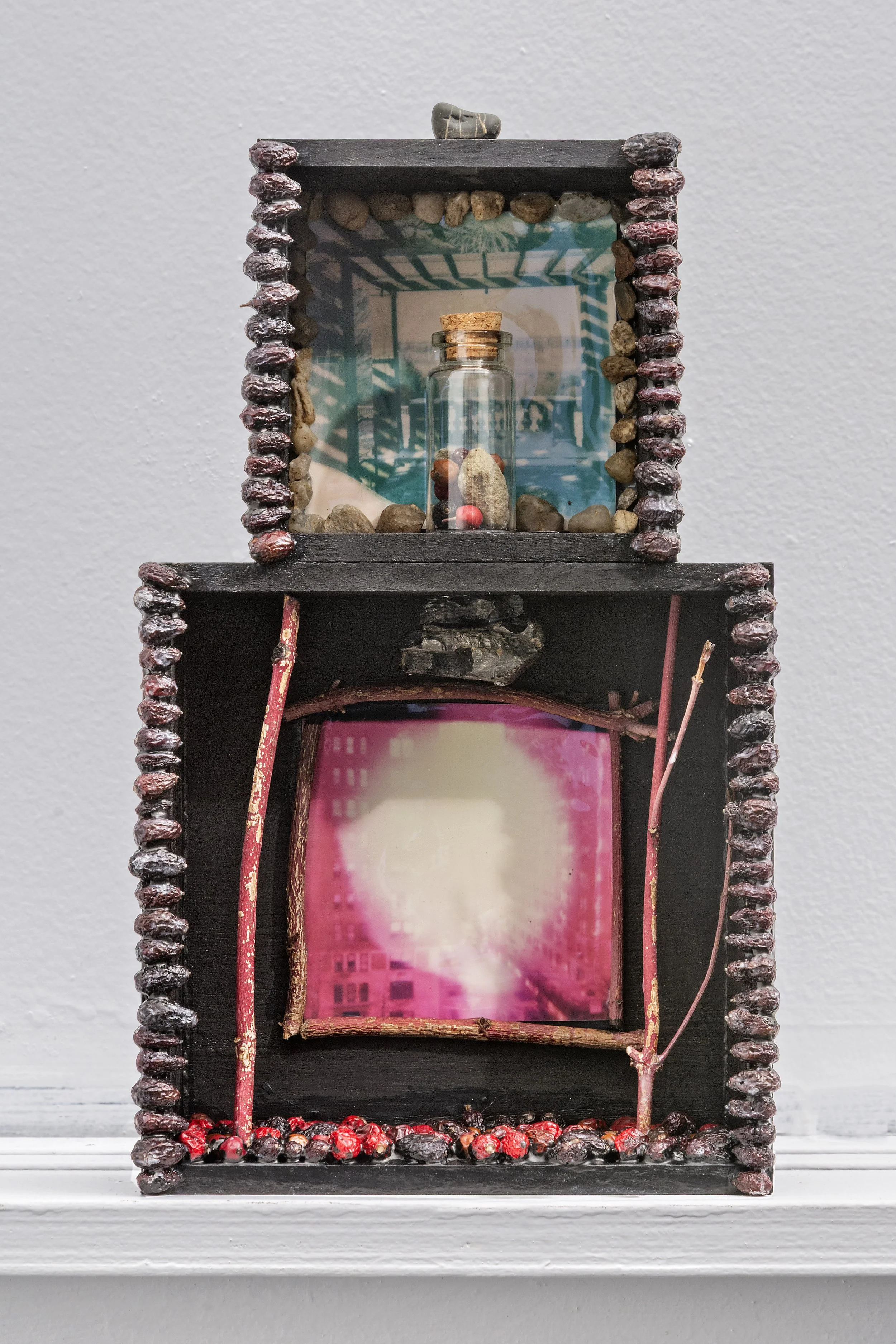 Melinda Kiefer Santiago,
Horizon Offering, 2025, polaroid prints, stones, seeds, branches, glass jar, acrylic, wood, 10 x 6 x 2 inches.