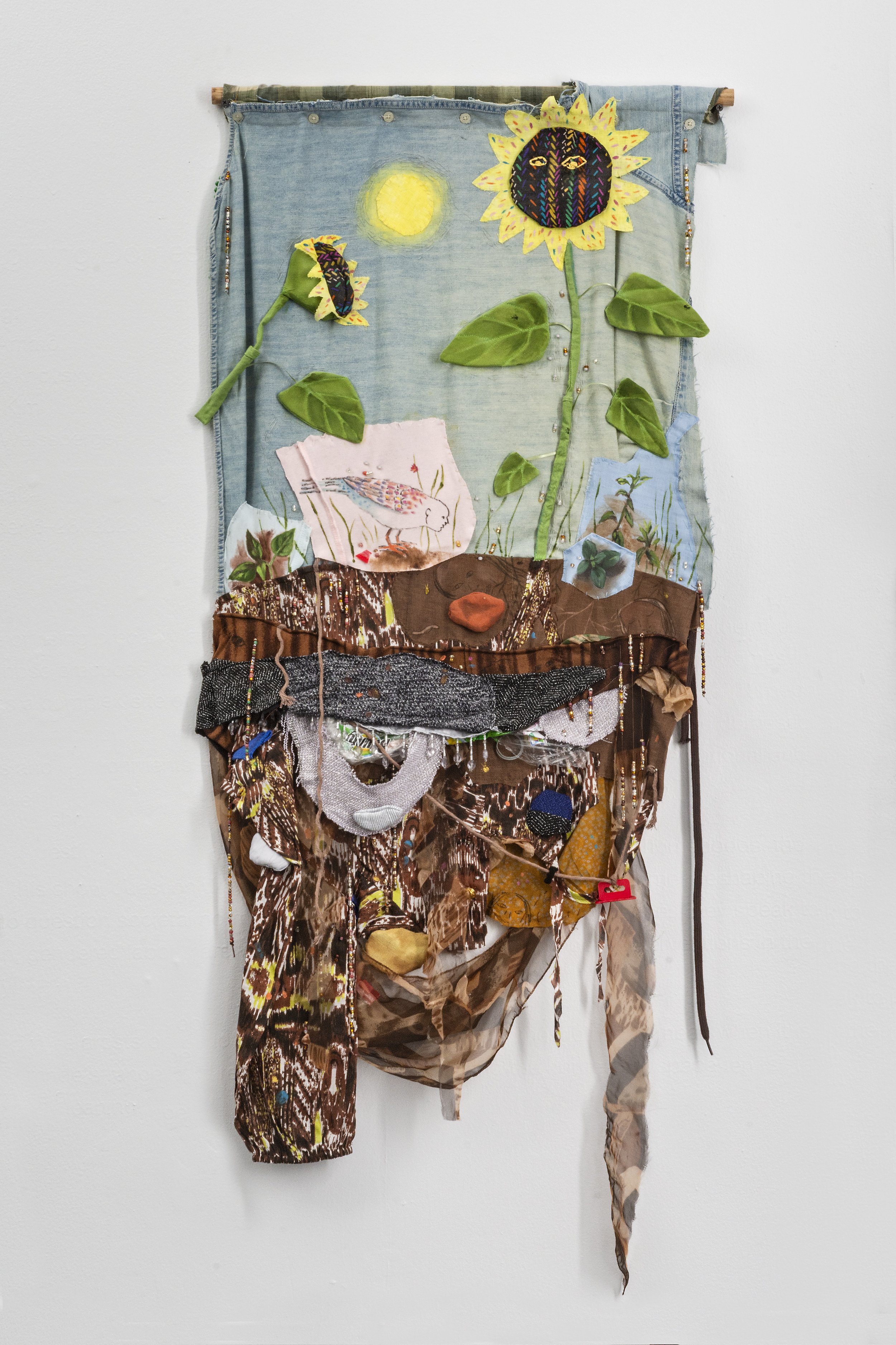 Katrina Slavik,
Self Portrait as Sunflower, 2025, Repurposed fabric, found plastic, embroidery, and beading, 50”h x 22”w.