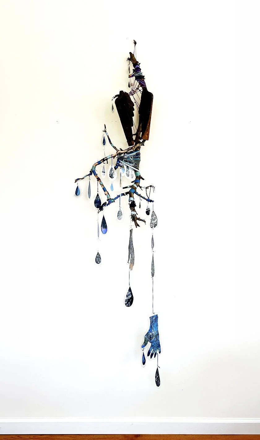 Skyfall, 2026, 72 x 24 x 20 inches, branches, string, digital prints of woods, mountains, and the Hudson River, found wooden wings, preglacial soil sample in jar  