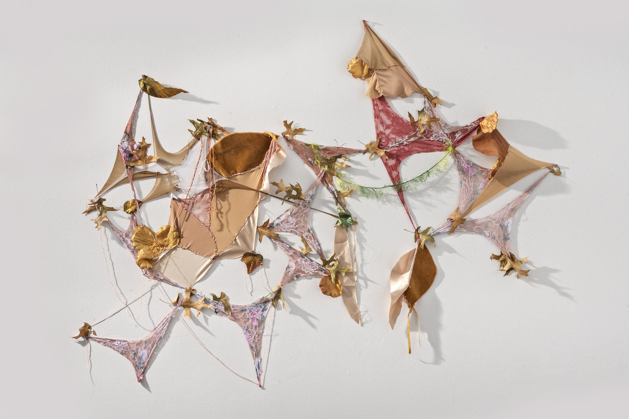 Yasmeen Abdallah,
Earthenbound, 2025, Assorted fabric, synthetic leaves, glitter, rubber band,and thread, dimensions variable.