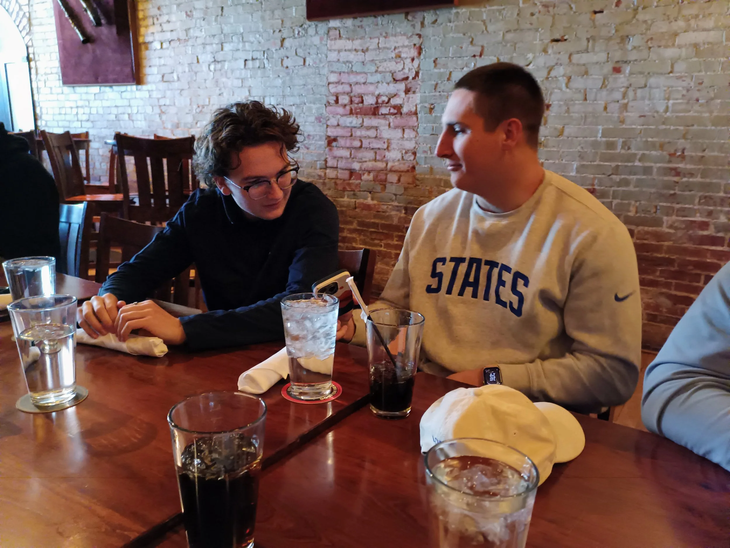 Ben Petrie and Cameron Logue look at each other while talking during lunch.
