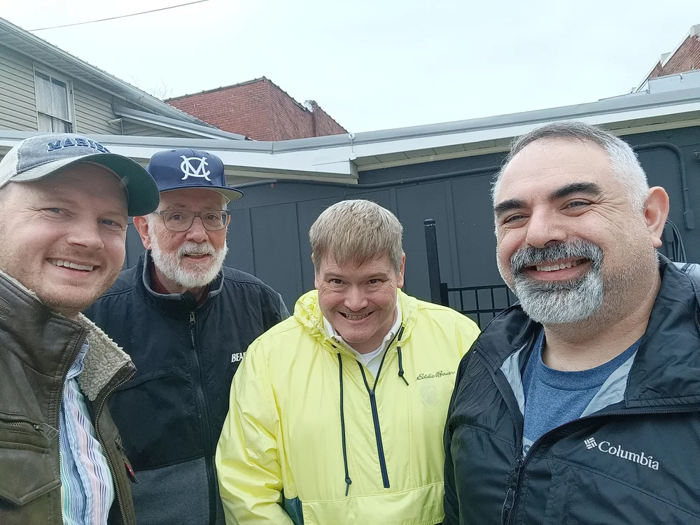 Four Delts in jackets smile for a selfie