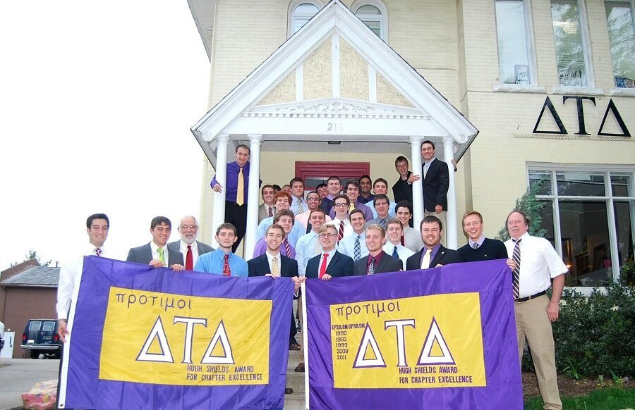 The Marietta Delts of 2013 proudly stand with their Hugh Shields flag.