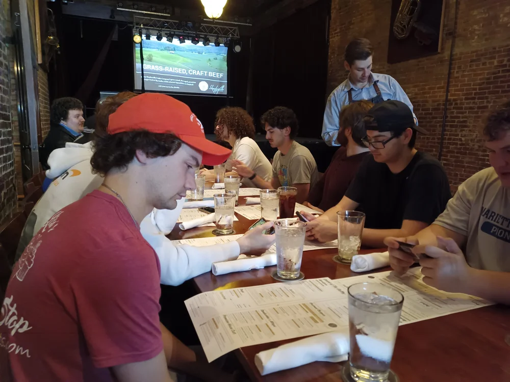 Undergraduate Delts look over the menu and place their orders at a previous lunch at the Galley.