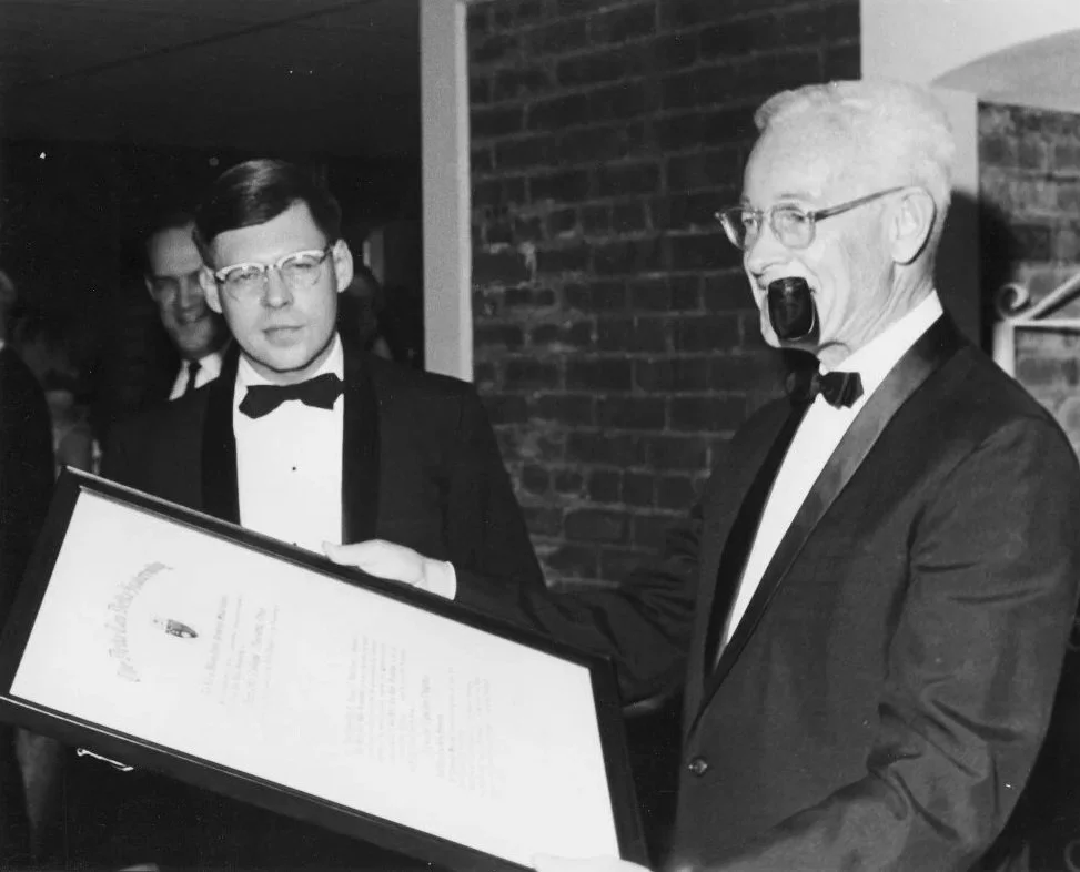 Walter Hobba stands holding the Charter.