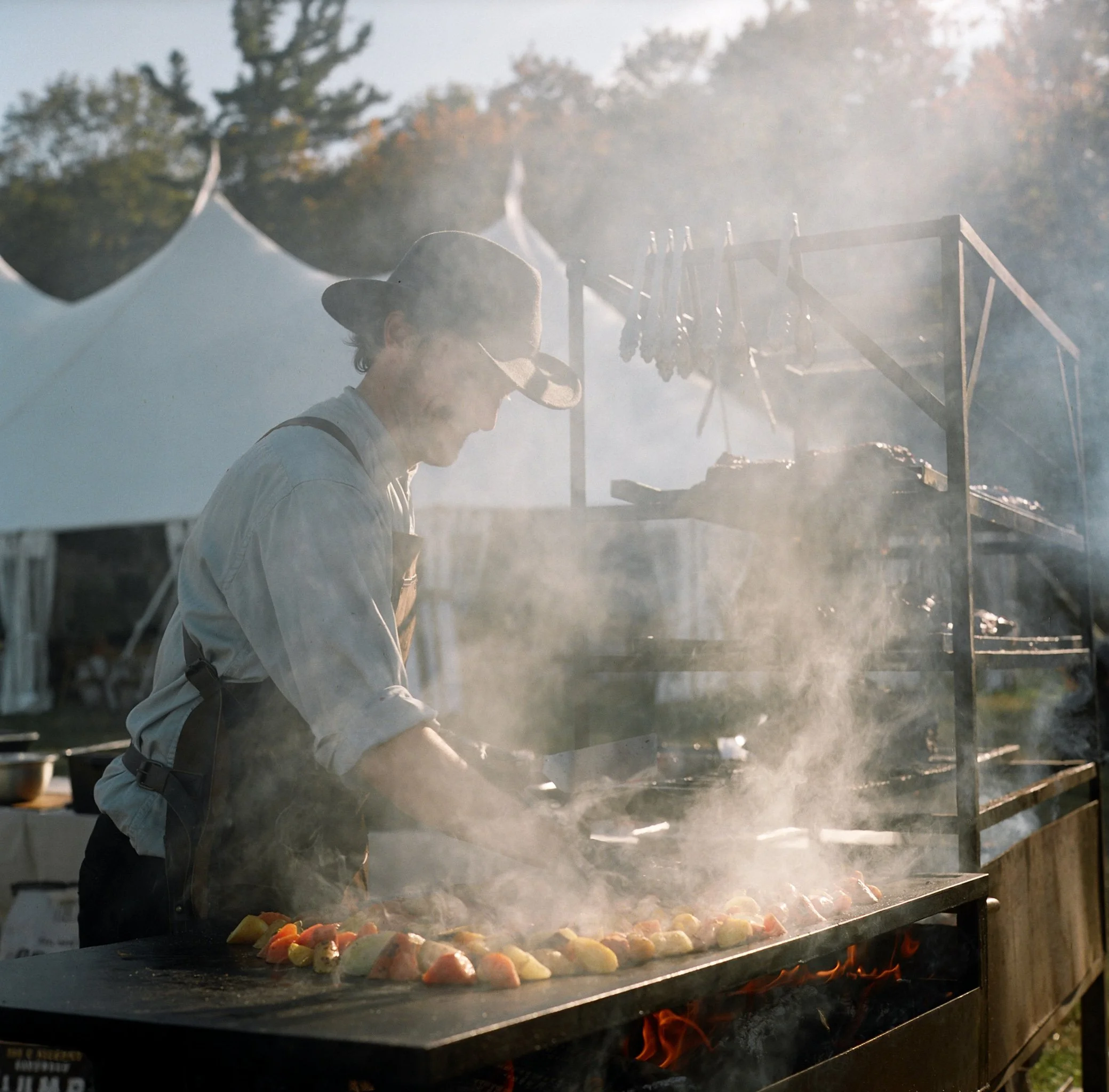 farm to table cooking in the orchard outside the tent
