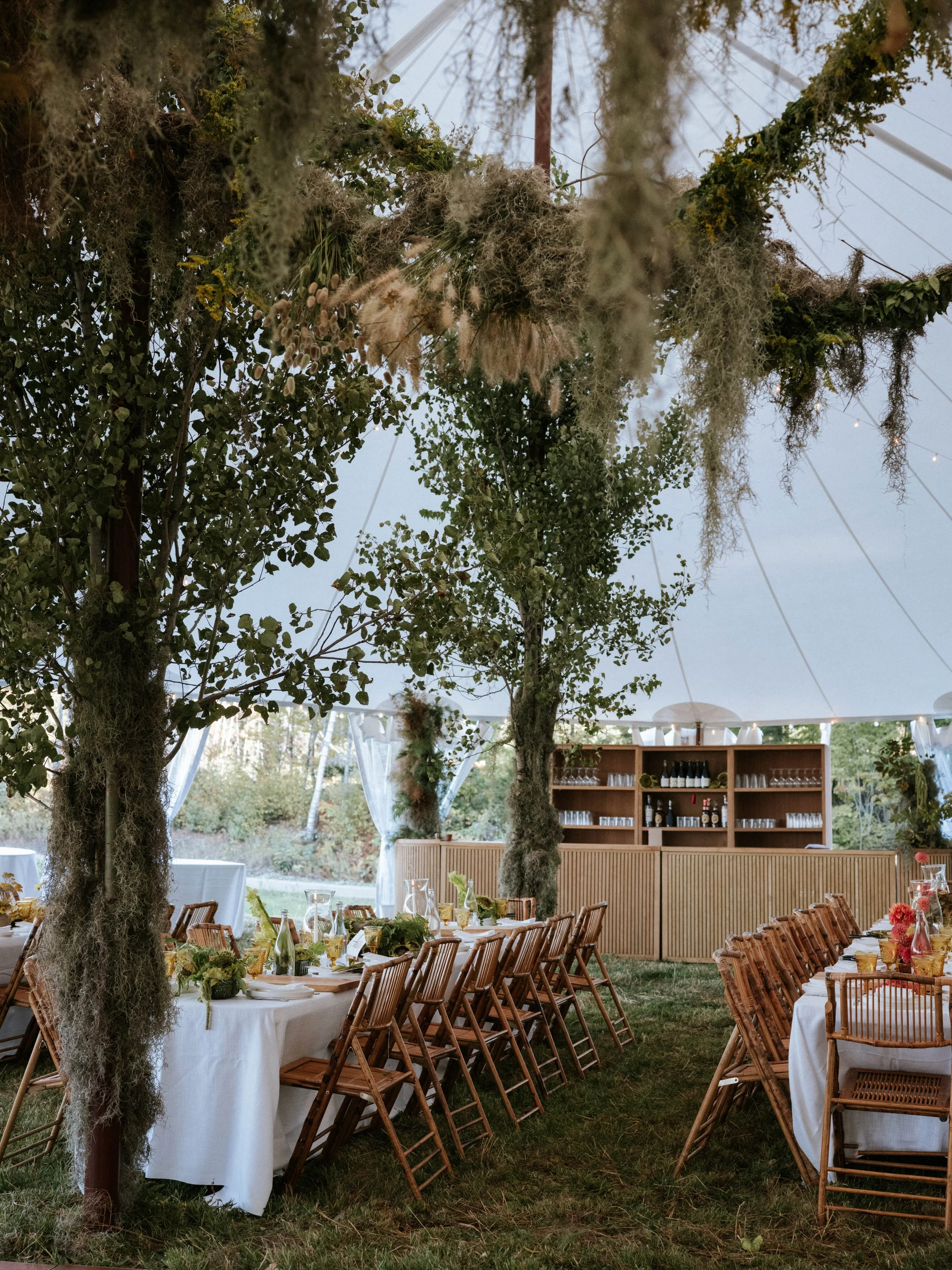 reception table scape set up with greenery and a bar 