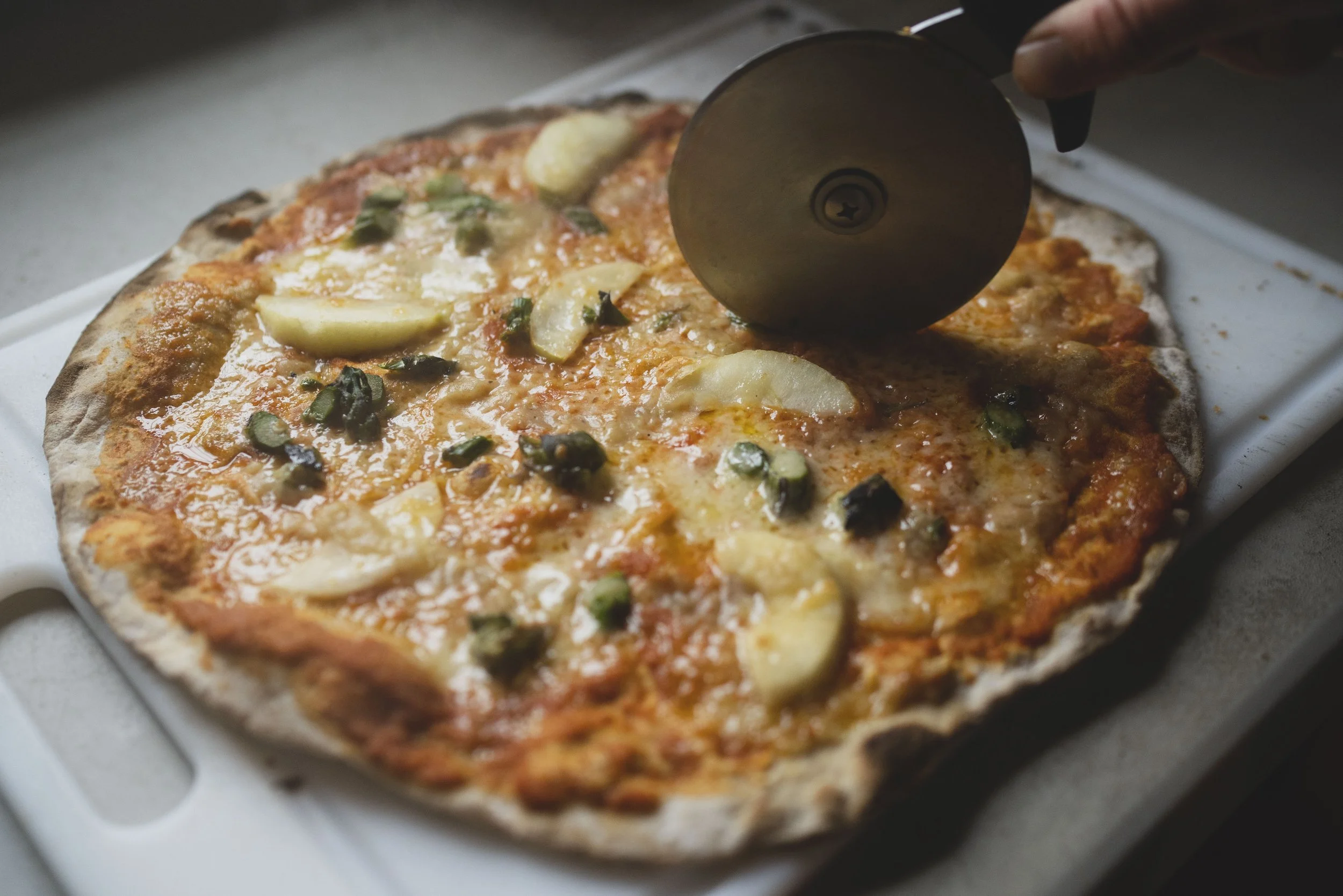 fresh made pizza being sliced