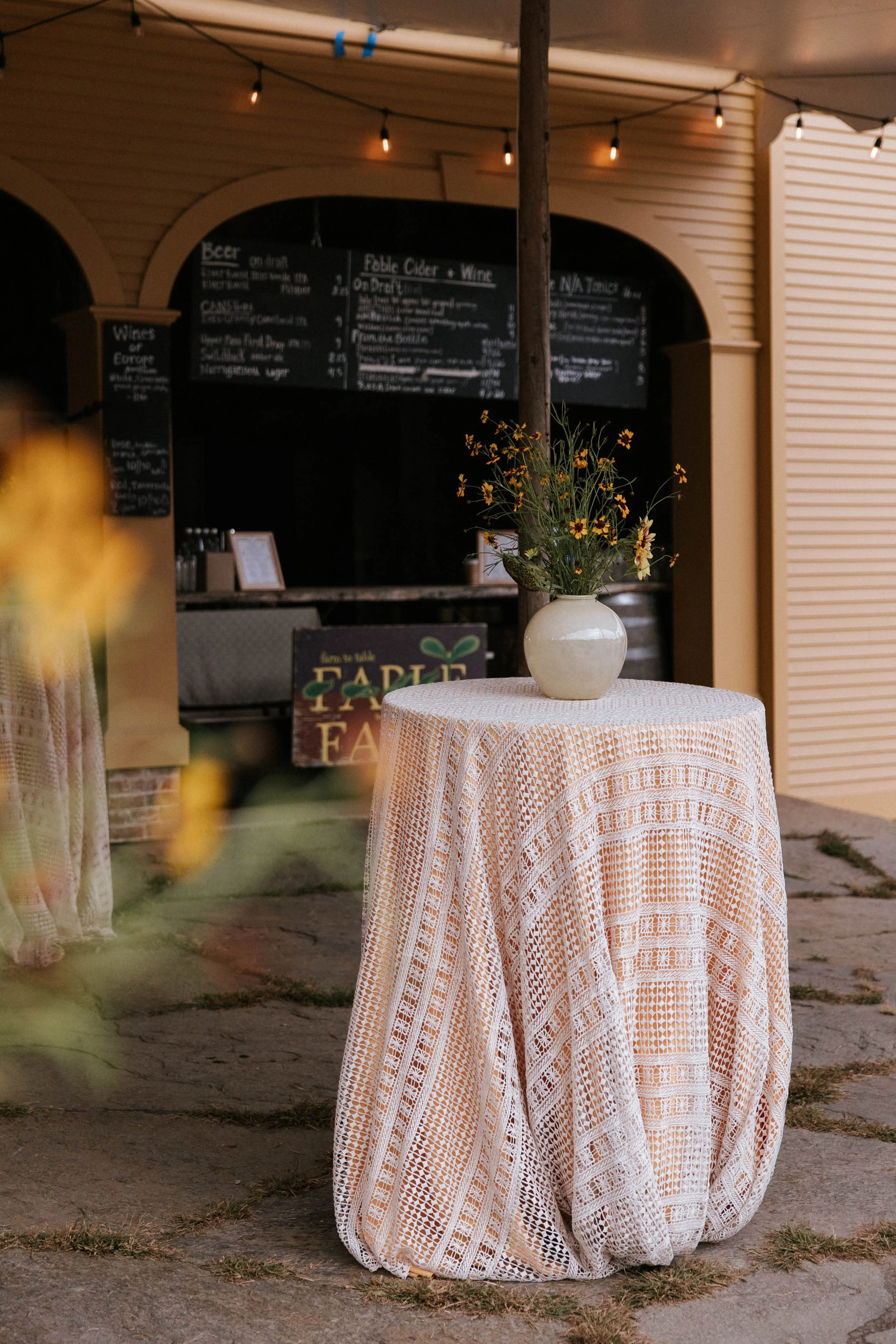 cocktail hour table outside the bar with peach tablecloth 