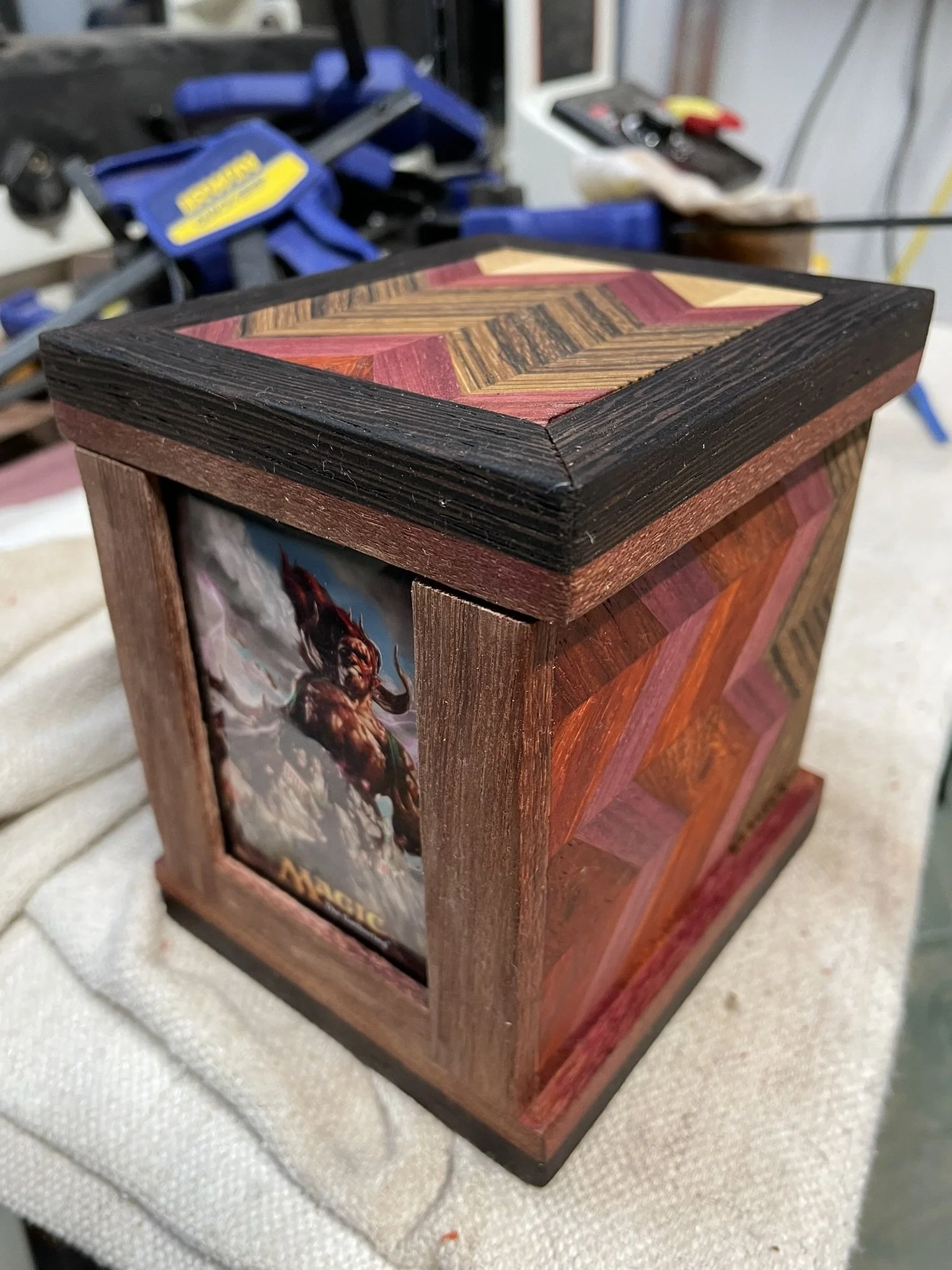 Card box made with a variety of woods and a sliding top. 