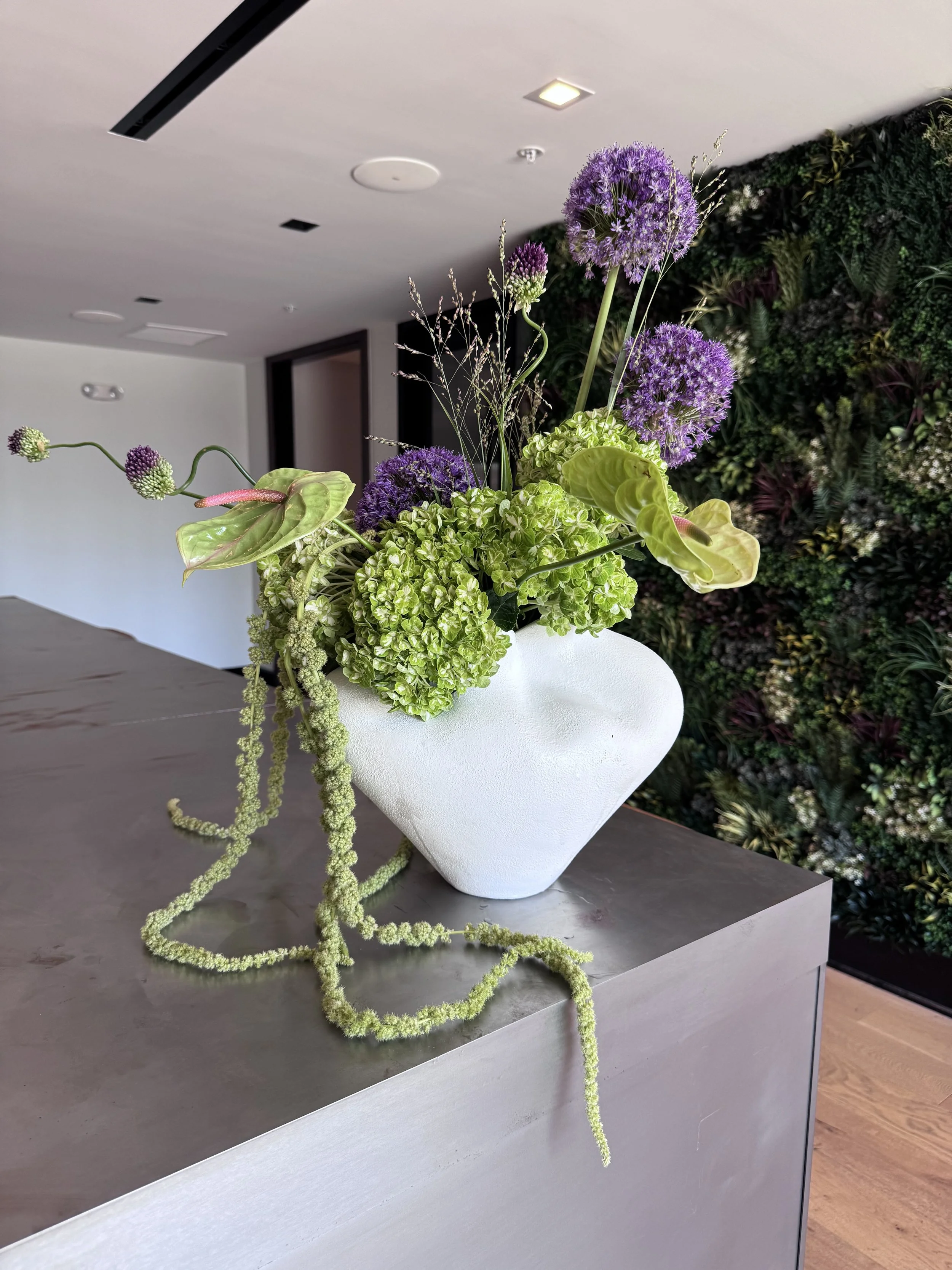 Weekly residential flowers incorporating seasonal blooms and an architectural silhouette for Durham luxury apartment.
