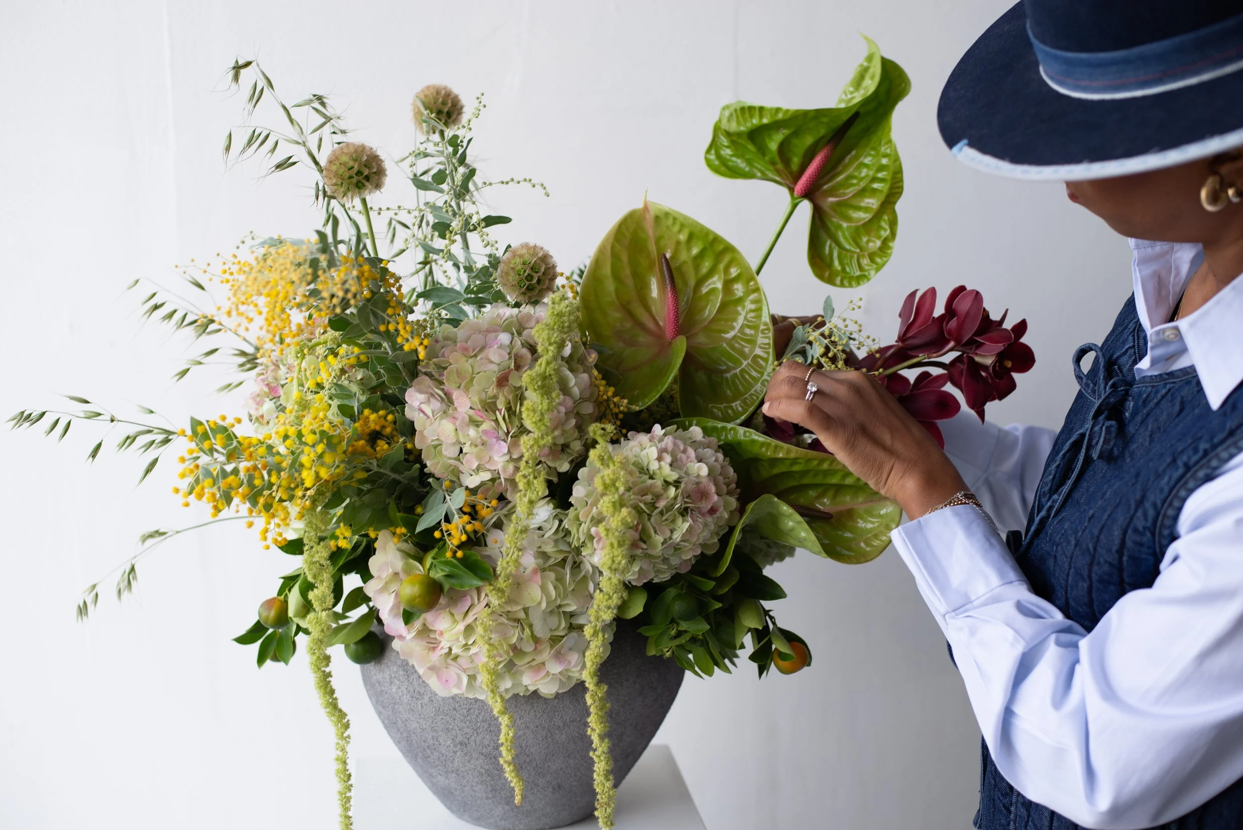 floral designer adjusting flowers