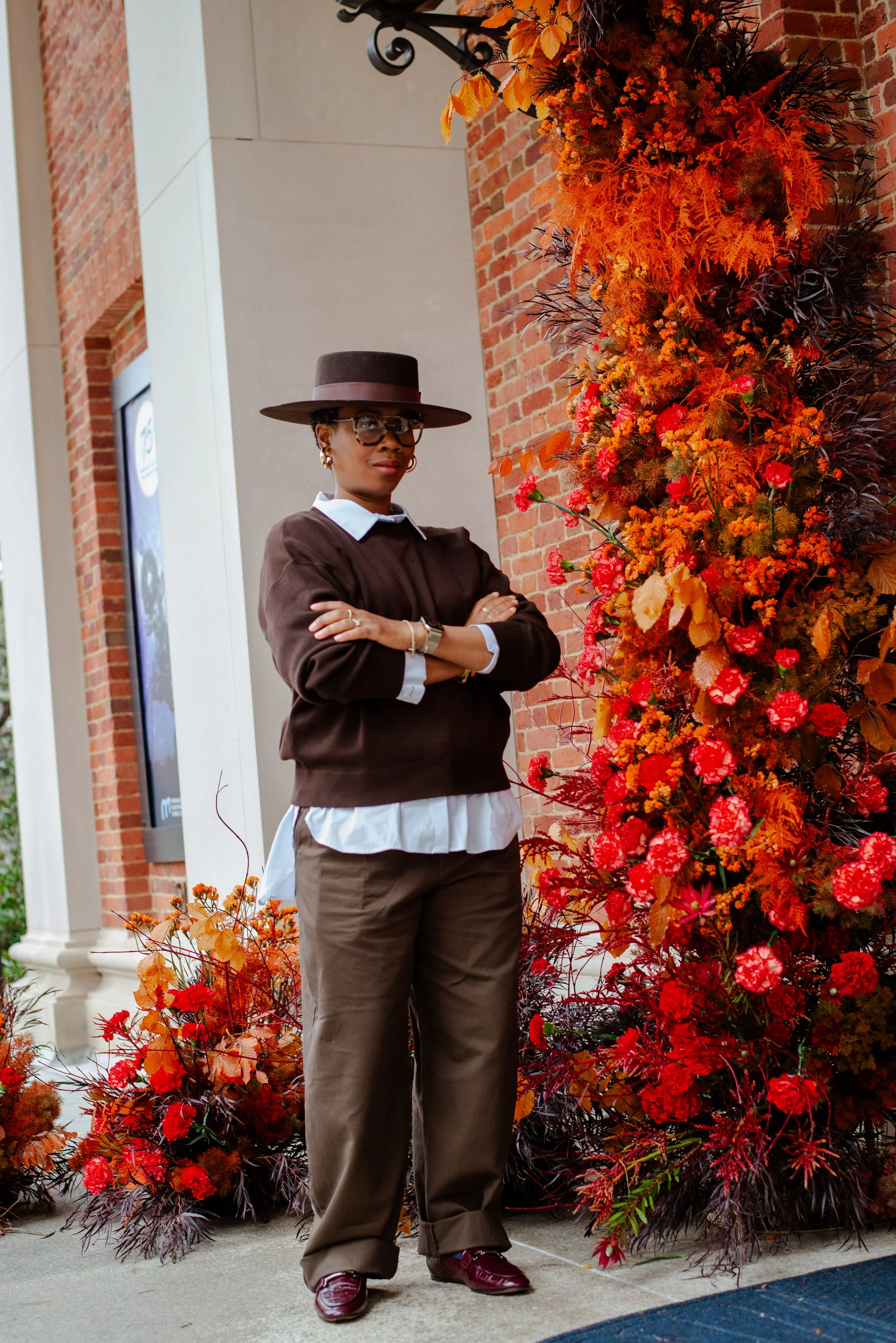 Lavish Leaf Founder/ Creative Director standing in front of large floral installation