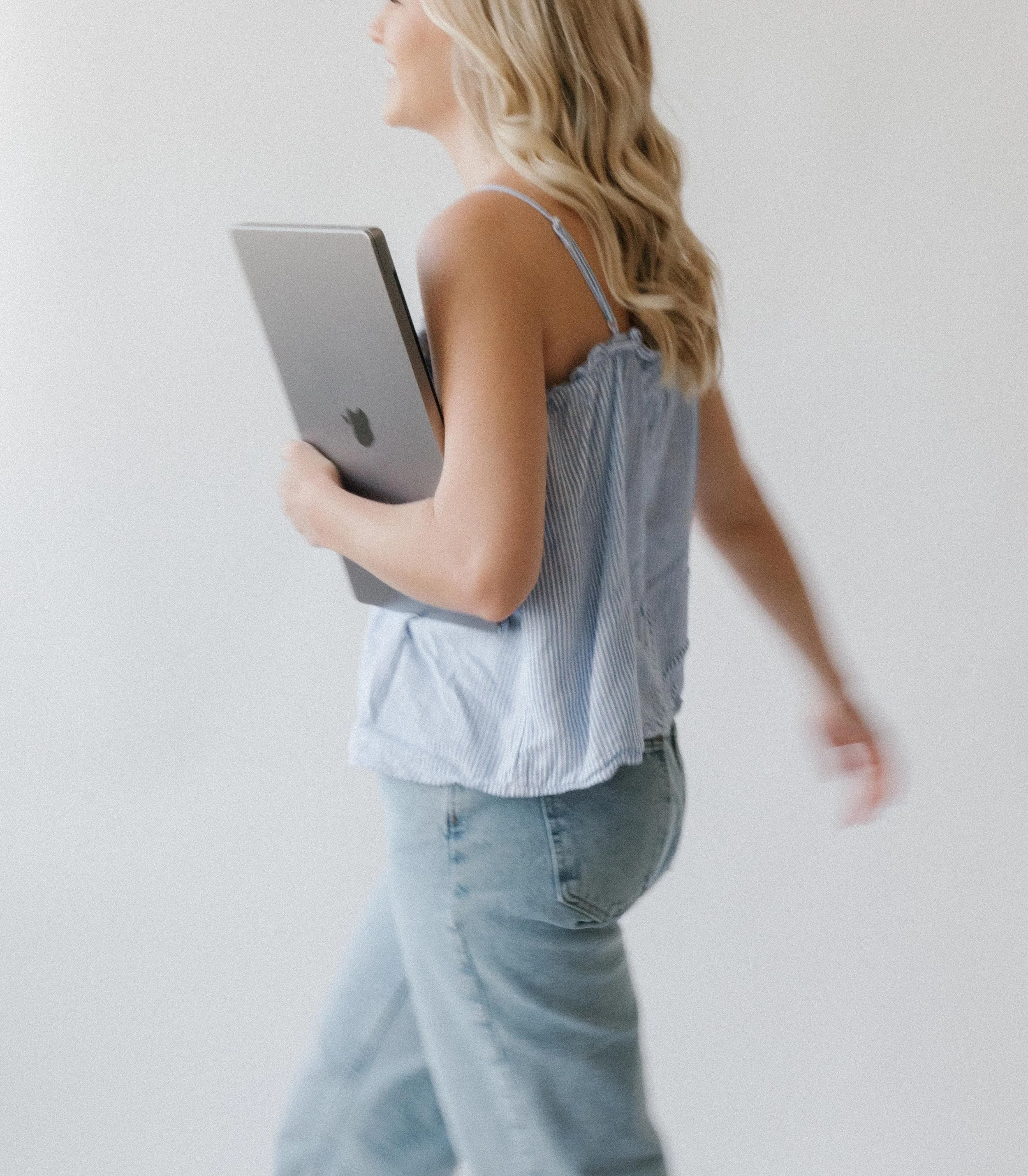 San Diego graphic designer holding a laptop during a personal branding photoshoot