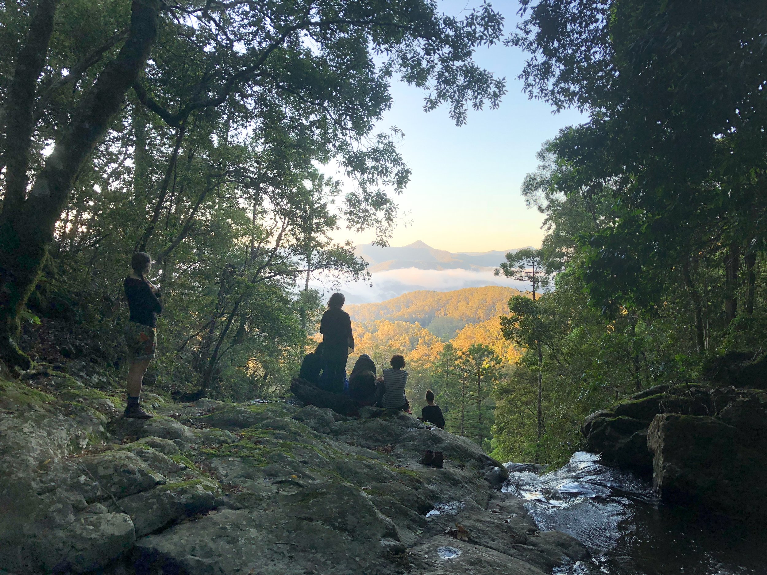 Reading Nature particpants enjoying the sunrise from the top of a waterfall.