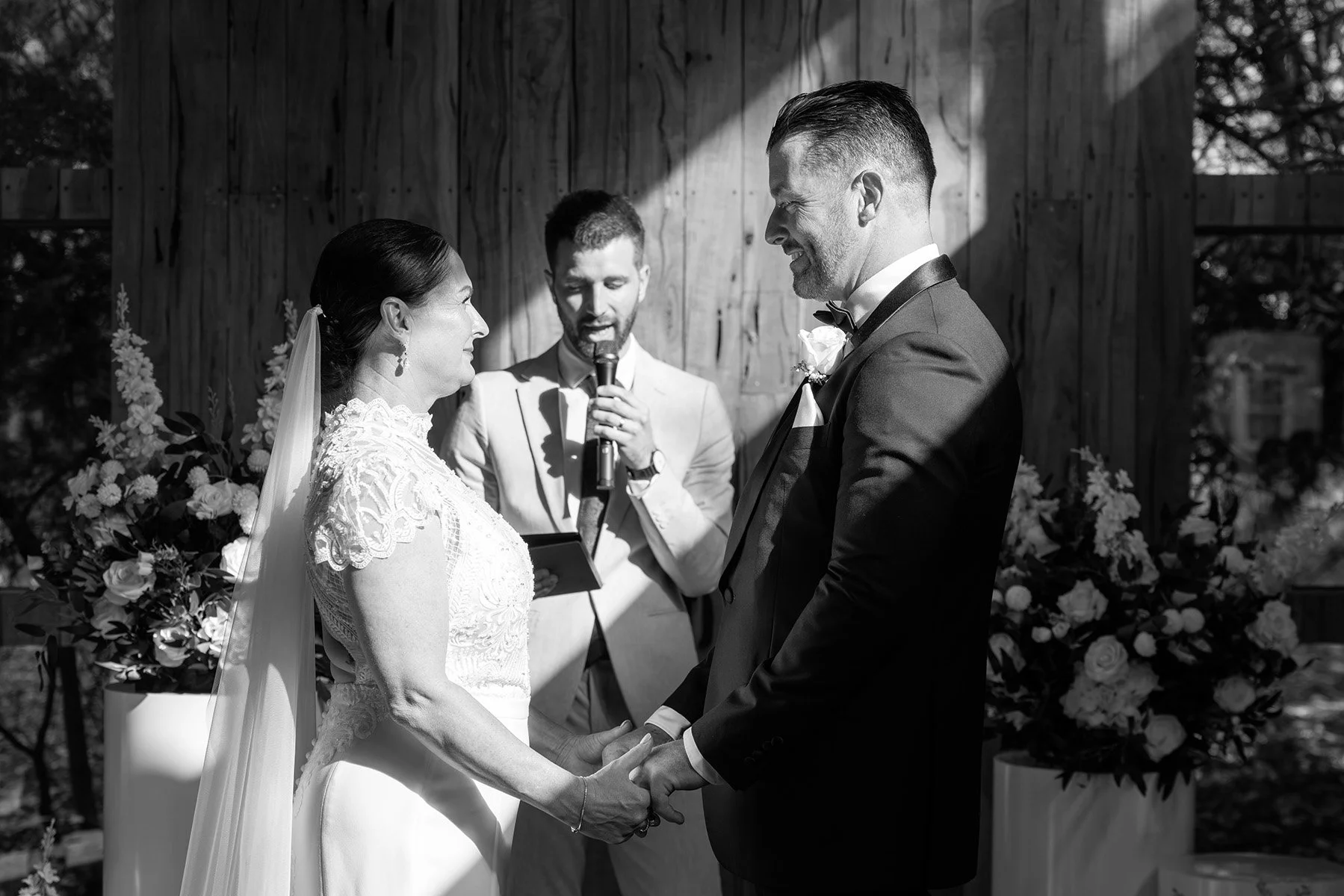 bride and groom smiling at each other with perth celebrant reading speech during a wedding ceremony