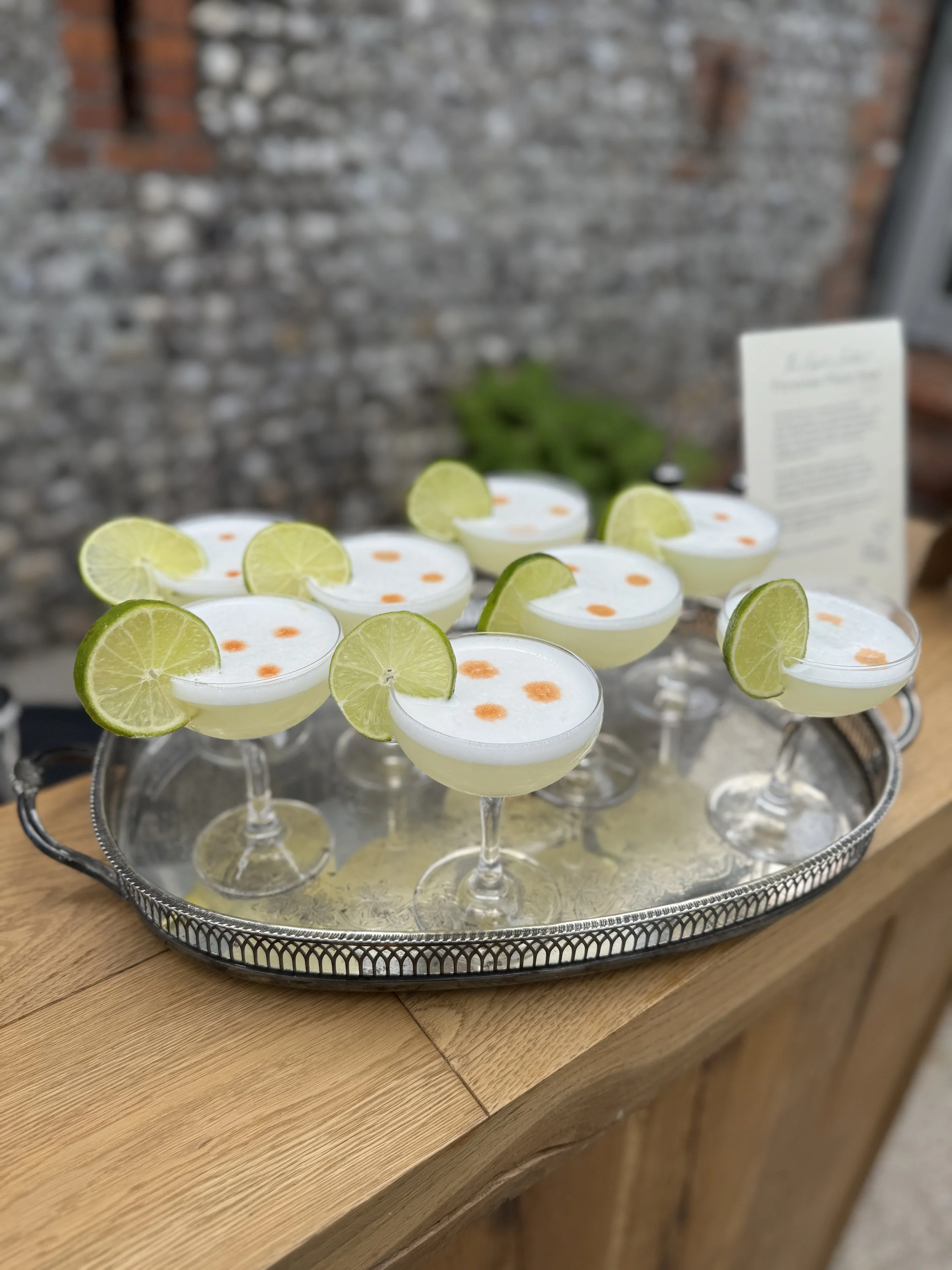 Pisco sours cocktails on a silver tray