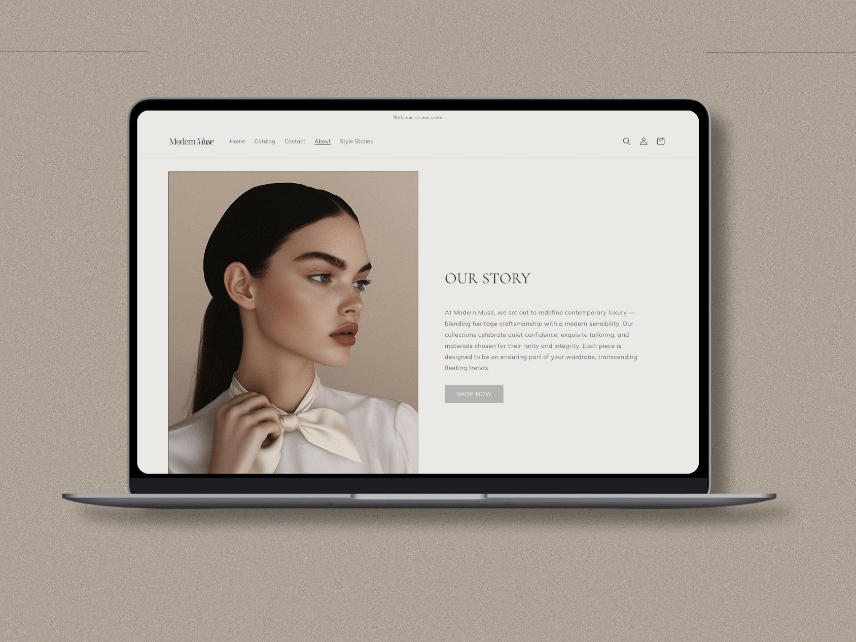 A laptop displaying a fashion website featuring a portrait of a woman with dark hair and makeup, wearing a white blouse and a bow tie, with a biography section titled 'Our Story'.
