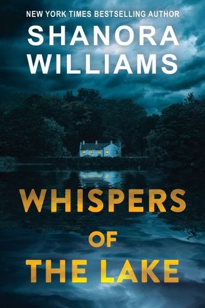 Book cover for "Whispers of the Lake" by Shanora Williams, featuring a dark, cloudy sky over a lake with a small, lit house amidst trees.