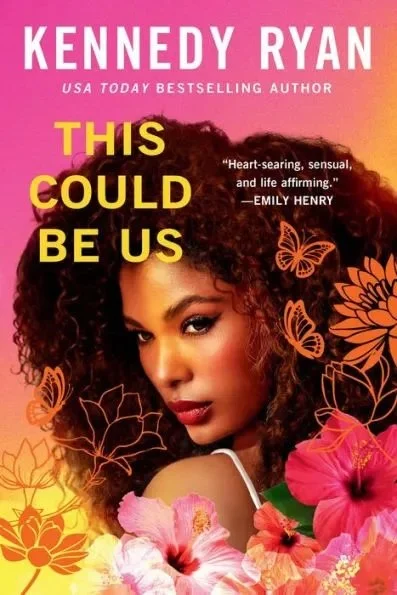 Book cover image of "This Could Be Us" by Kennedy Ryan displayed on a library website. The cover features a woman with flowers and butterflies against a colorful background.