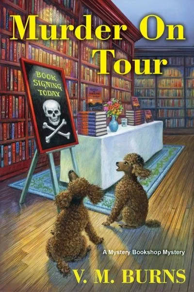 Book cover titled 'Murder On Tour' by V. M. Burns showing two dogs sitting in a bookstore, looking at a sign that says 'Book Signing Today' with a skull and crossbones.