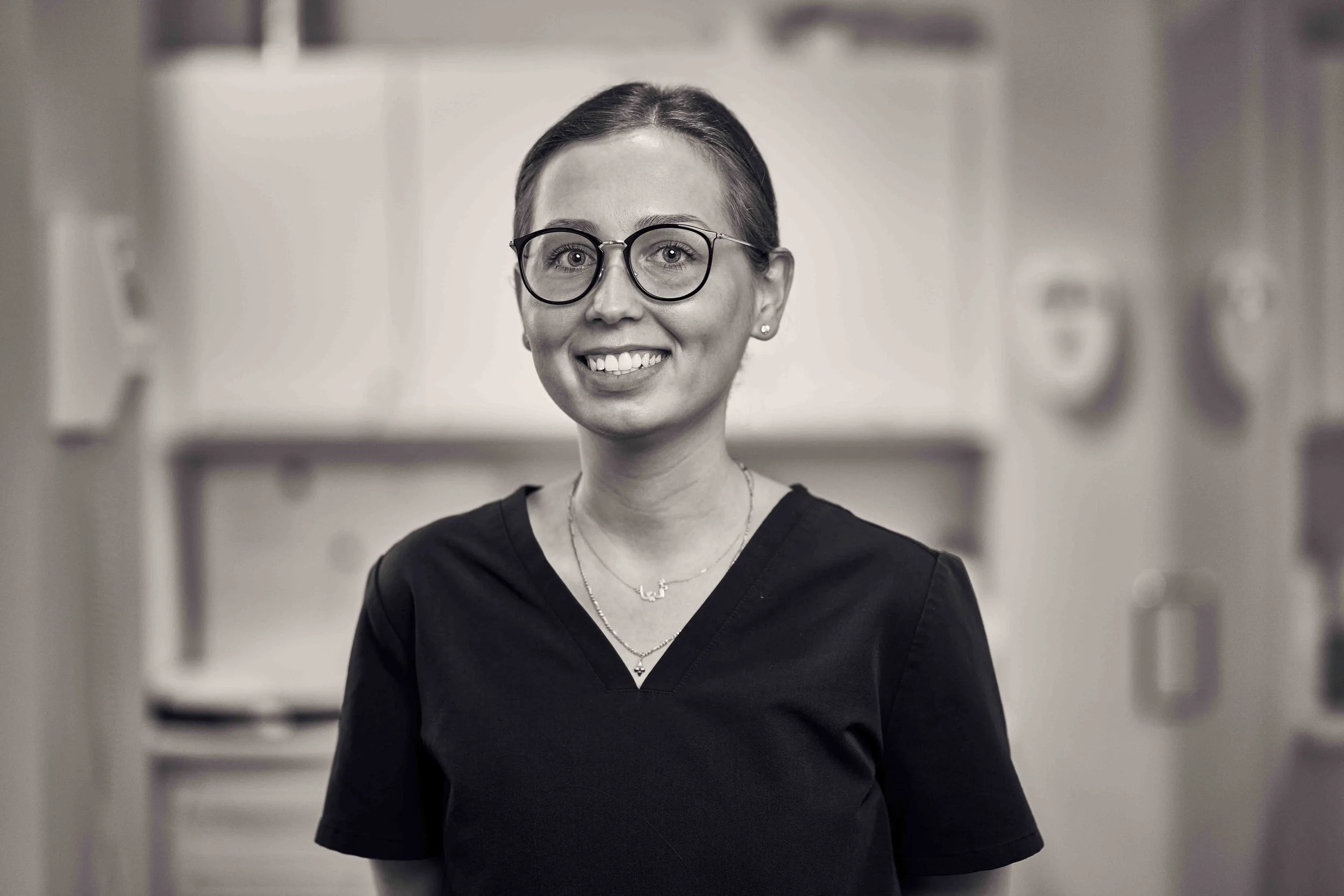 Fire bambus tandbørster med blå børstehår i en glasbeholder og grøn eucalyptus blade på en hvid overflade.