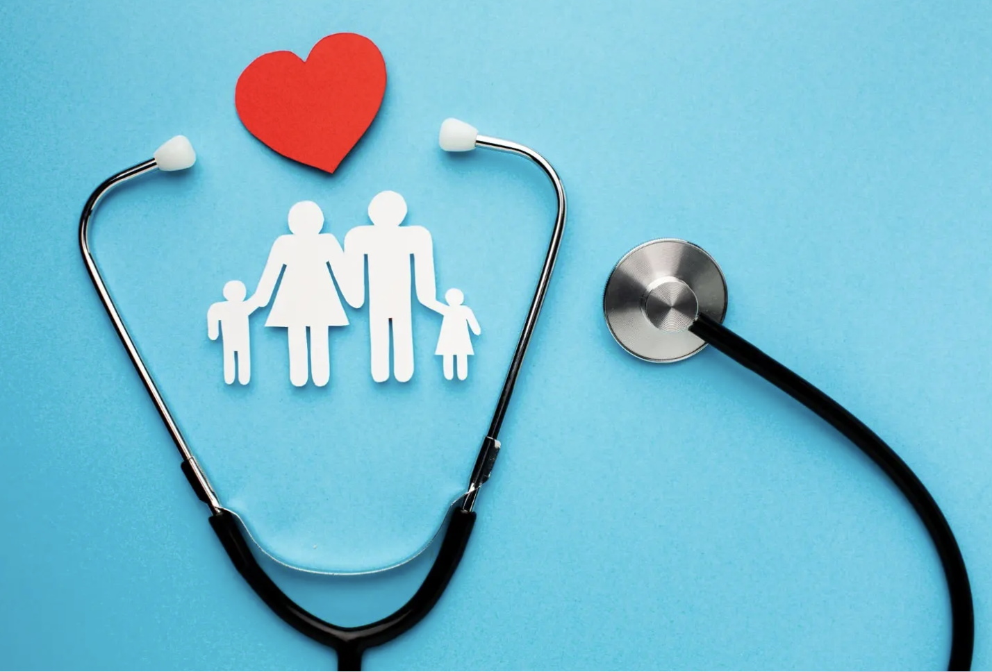 Stethoscope arranged around paper cutout of a family with a red heart above on a blue background.