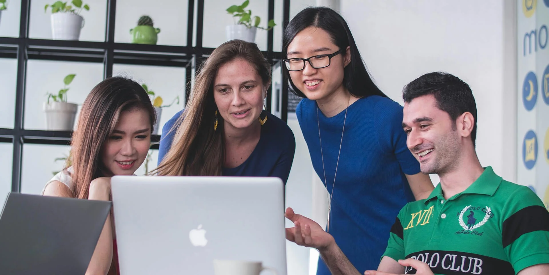 group of people looking at a laptop